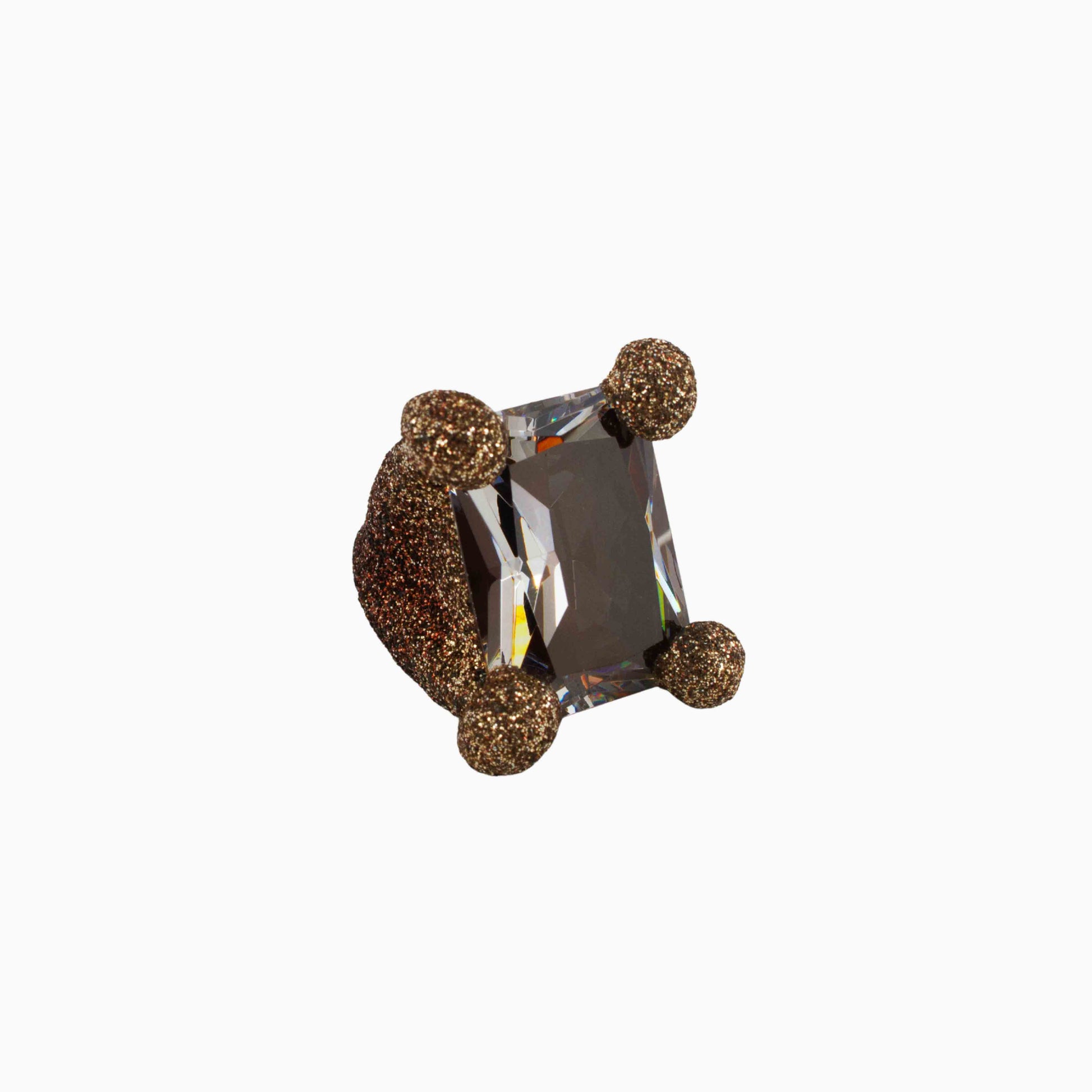 Decorative ring with a central gemstone and gold accents on a white background