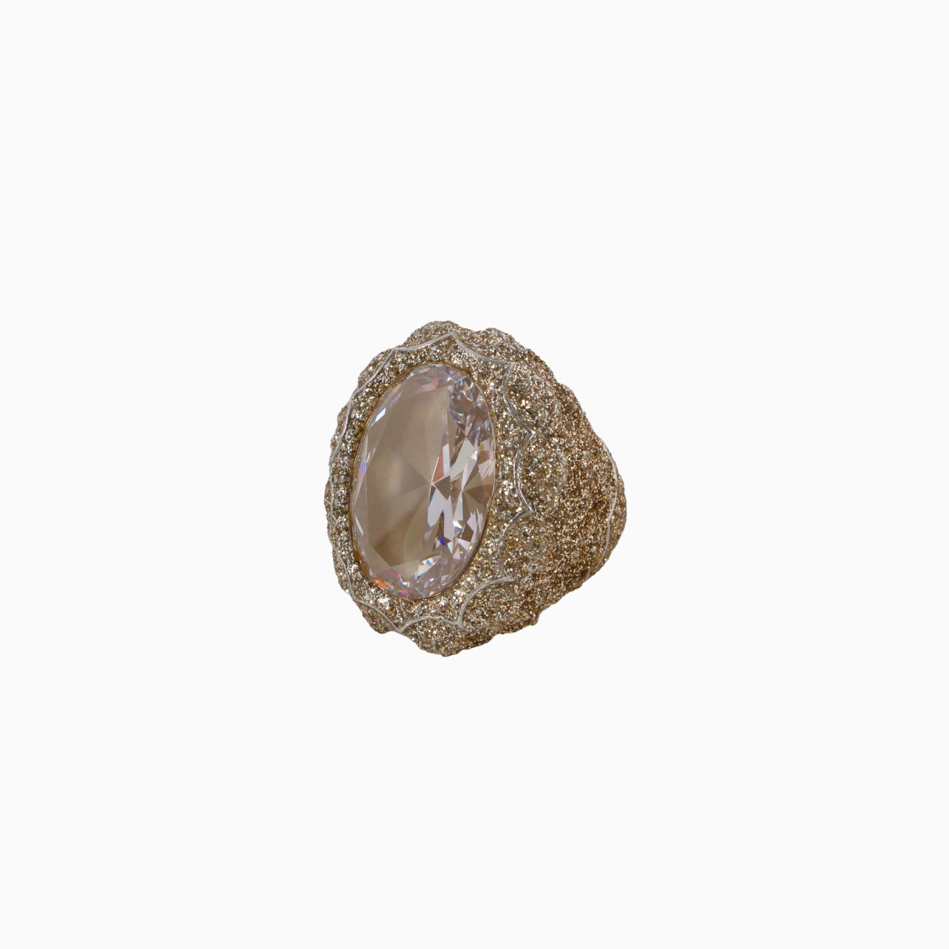 Gold ring with a large gemstone on a white background