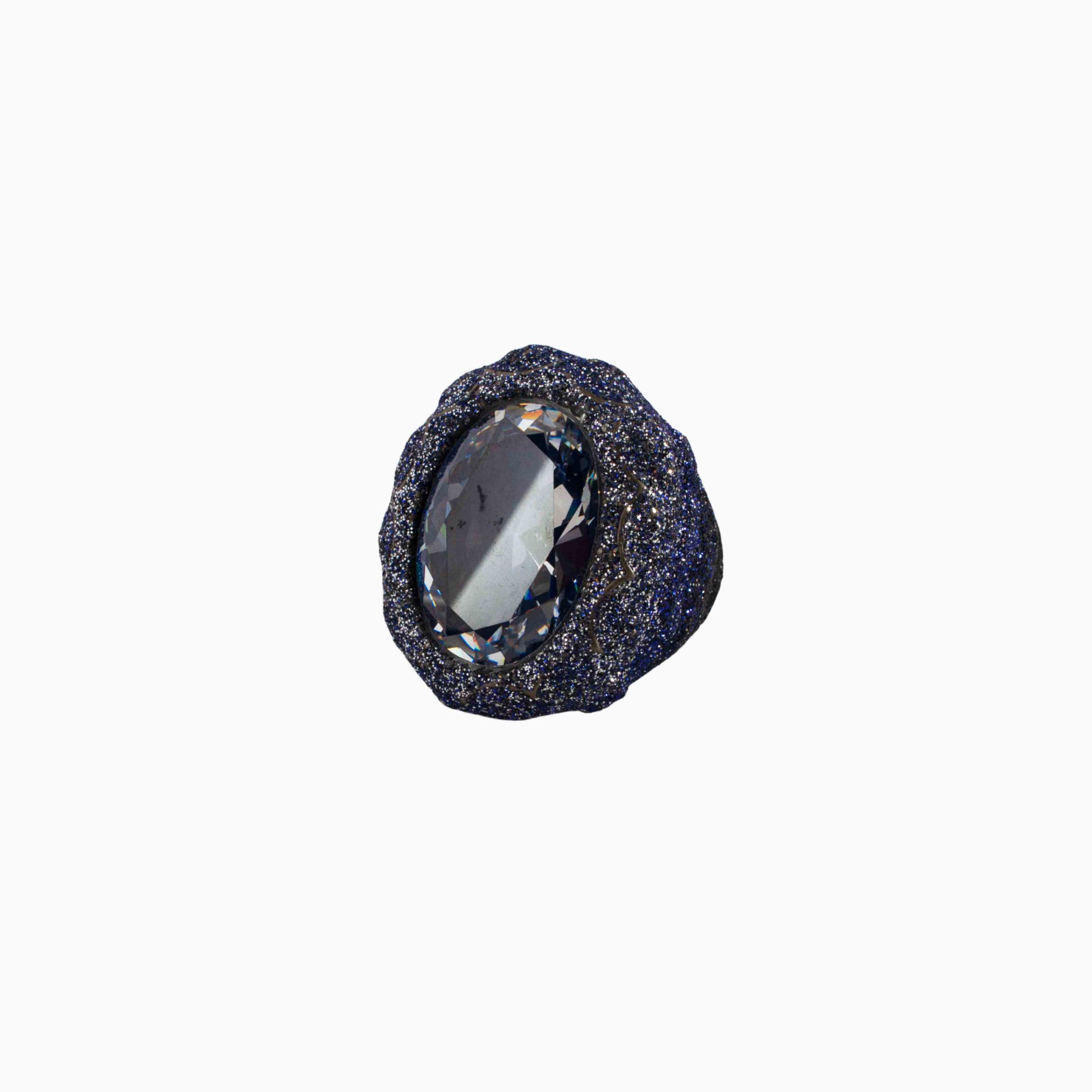 Black stone with a central clear gemstone on a white background