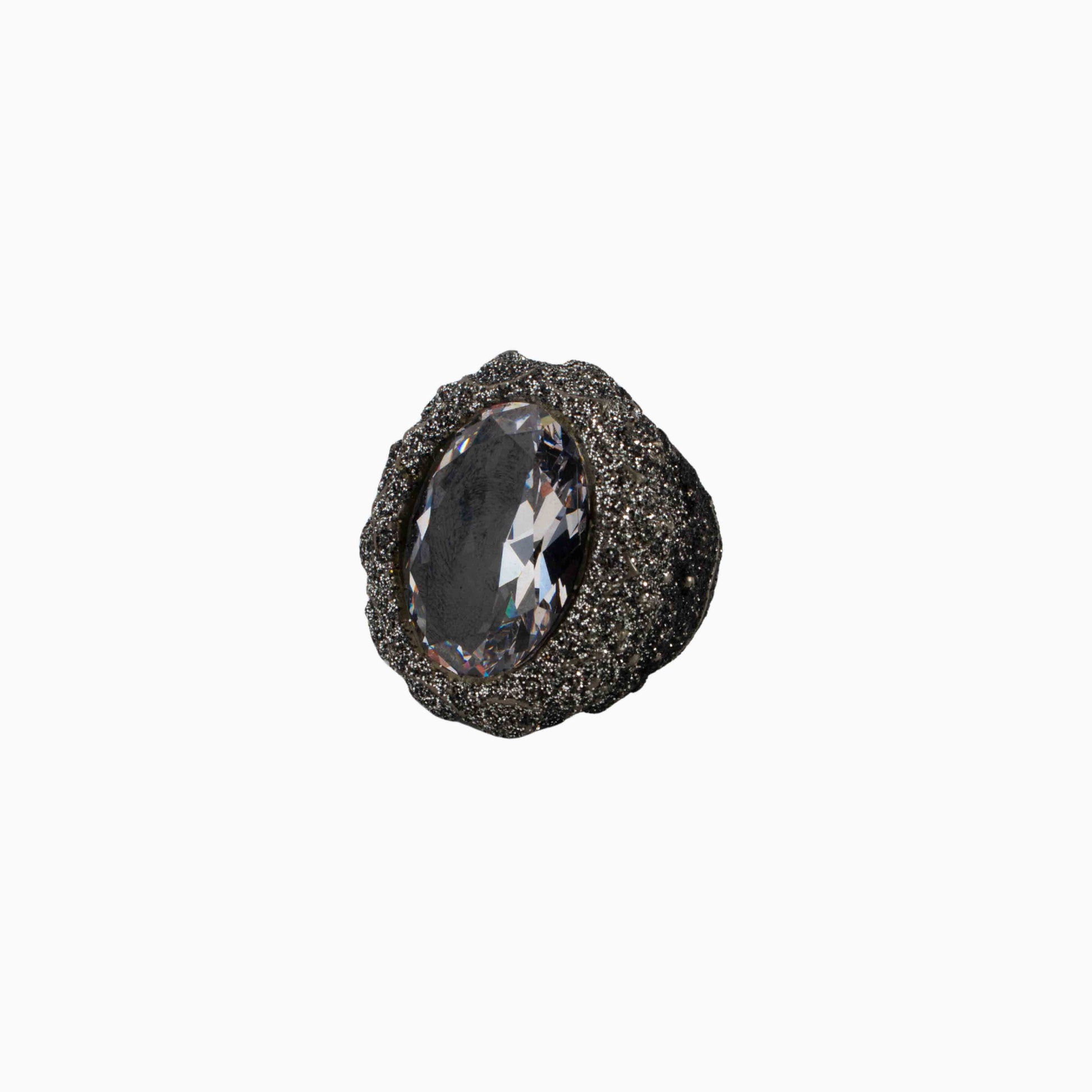 Decorative knob with a textured surface and central gemstone on a white background
