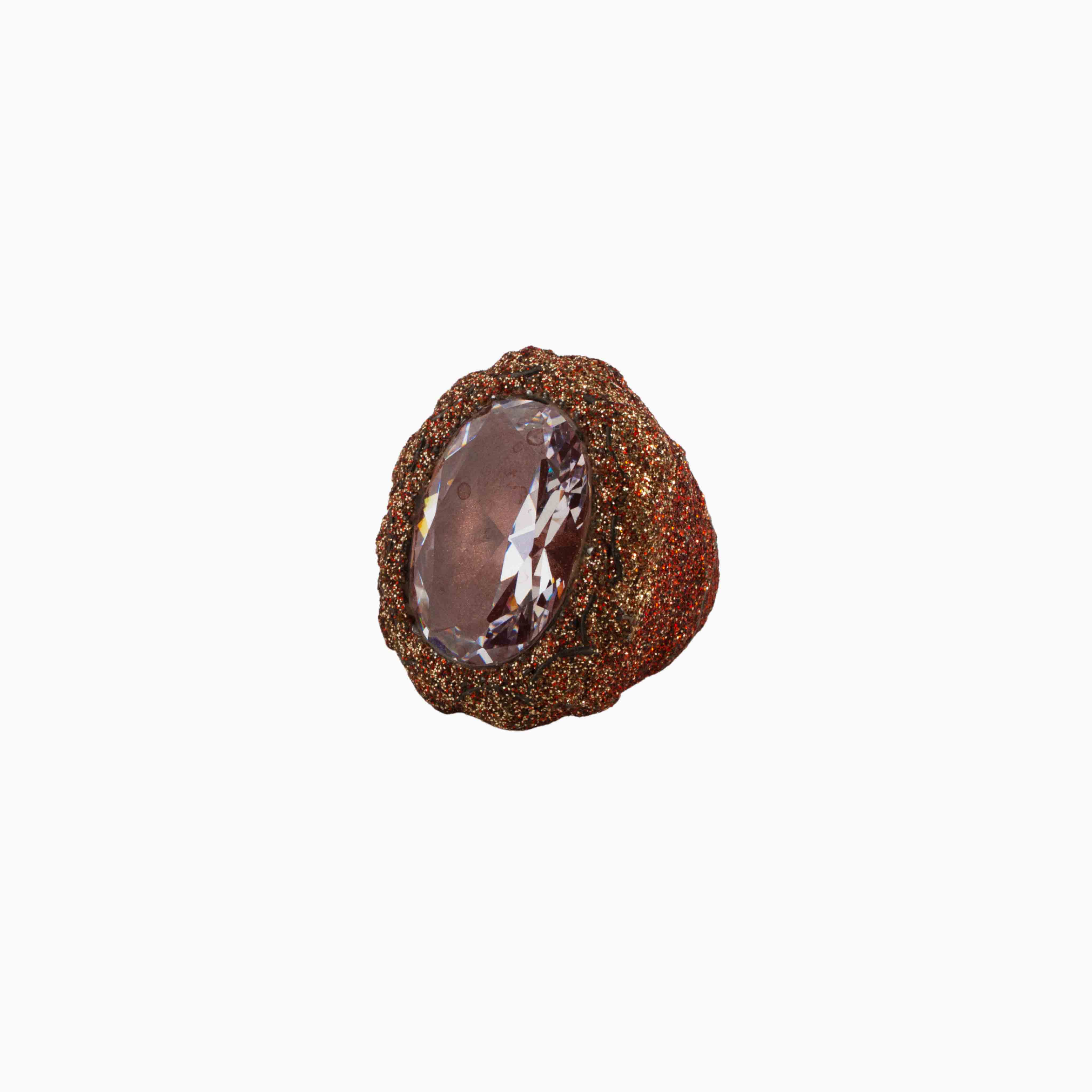 Brown textured ring with a clear gemstone on a white background