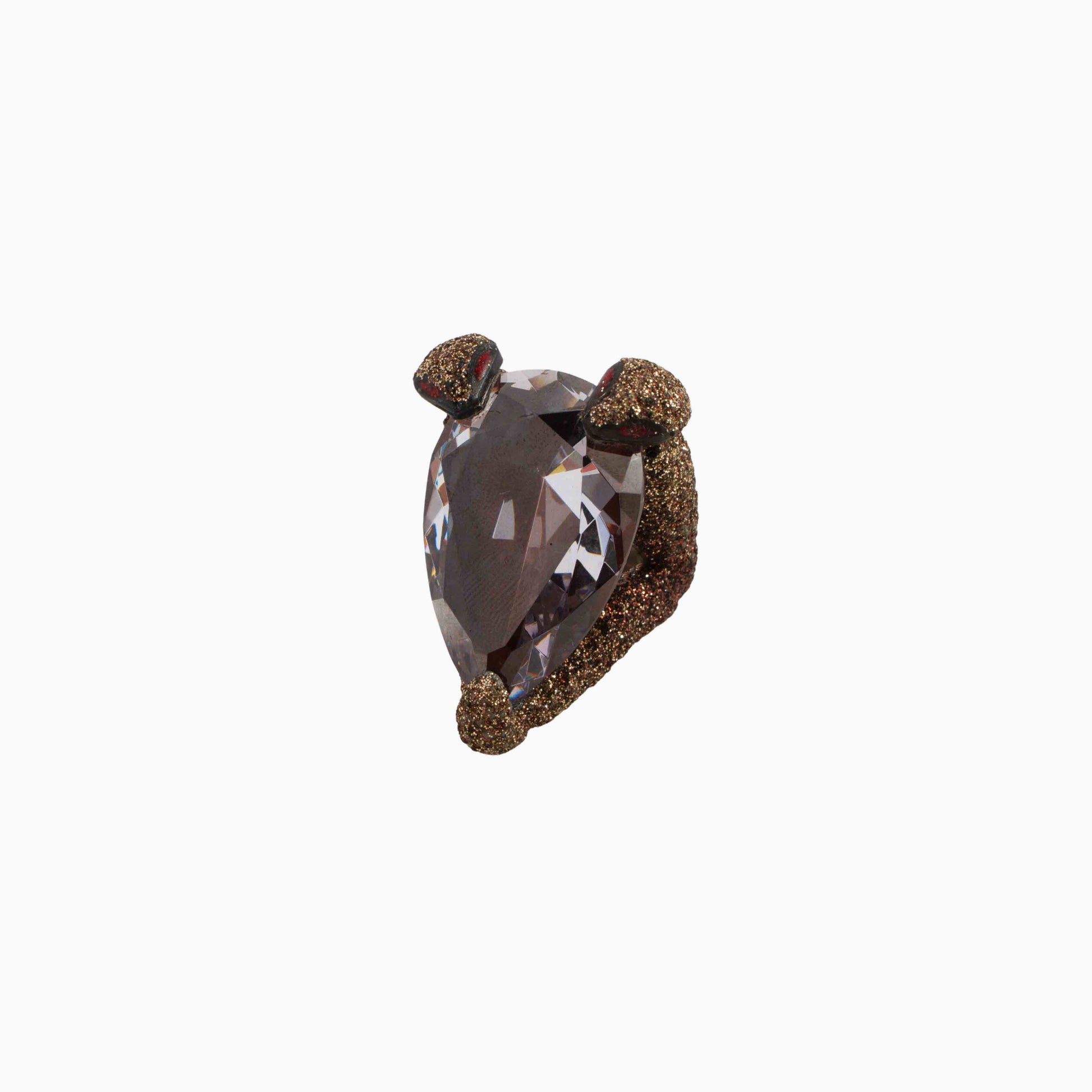Heart-shaped brown gemstone with gold setting on a white background