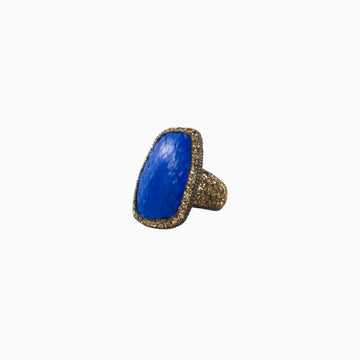Ring with blue stone and gold accents on a white background