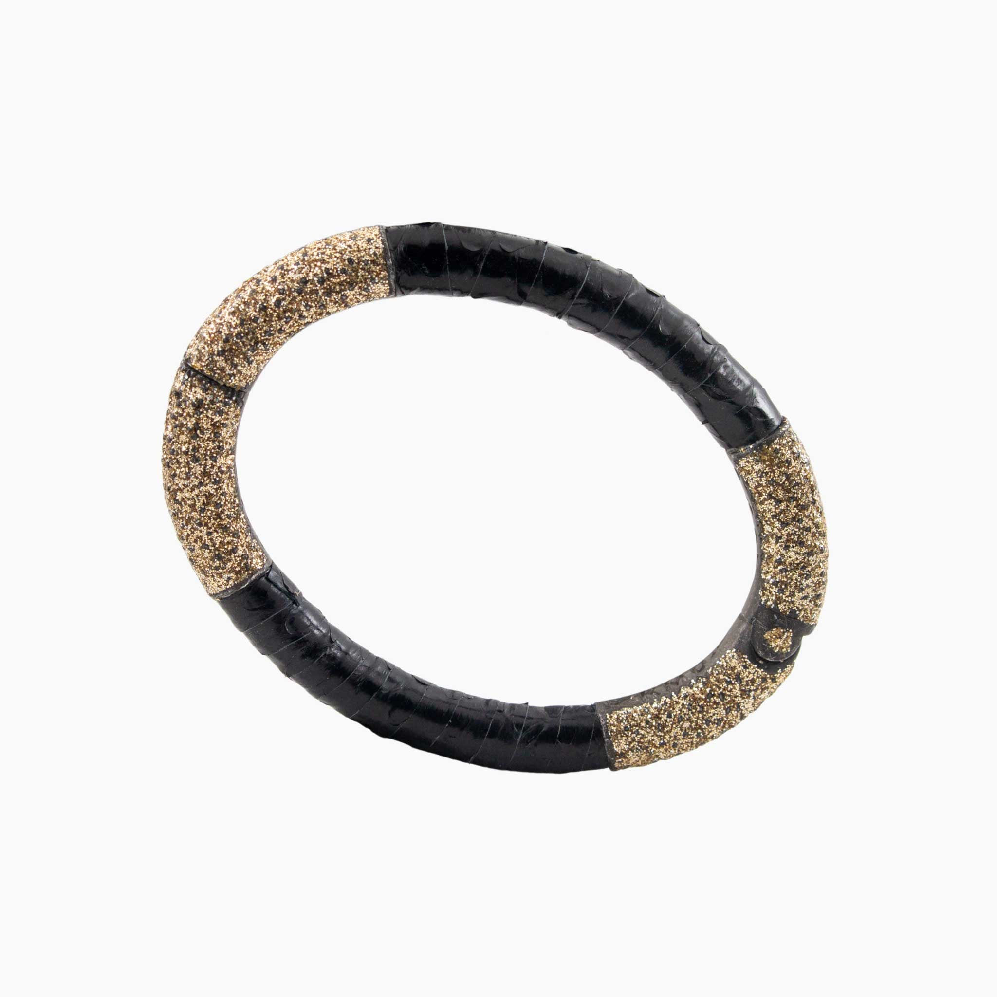 Black and gold bracelet on a white background