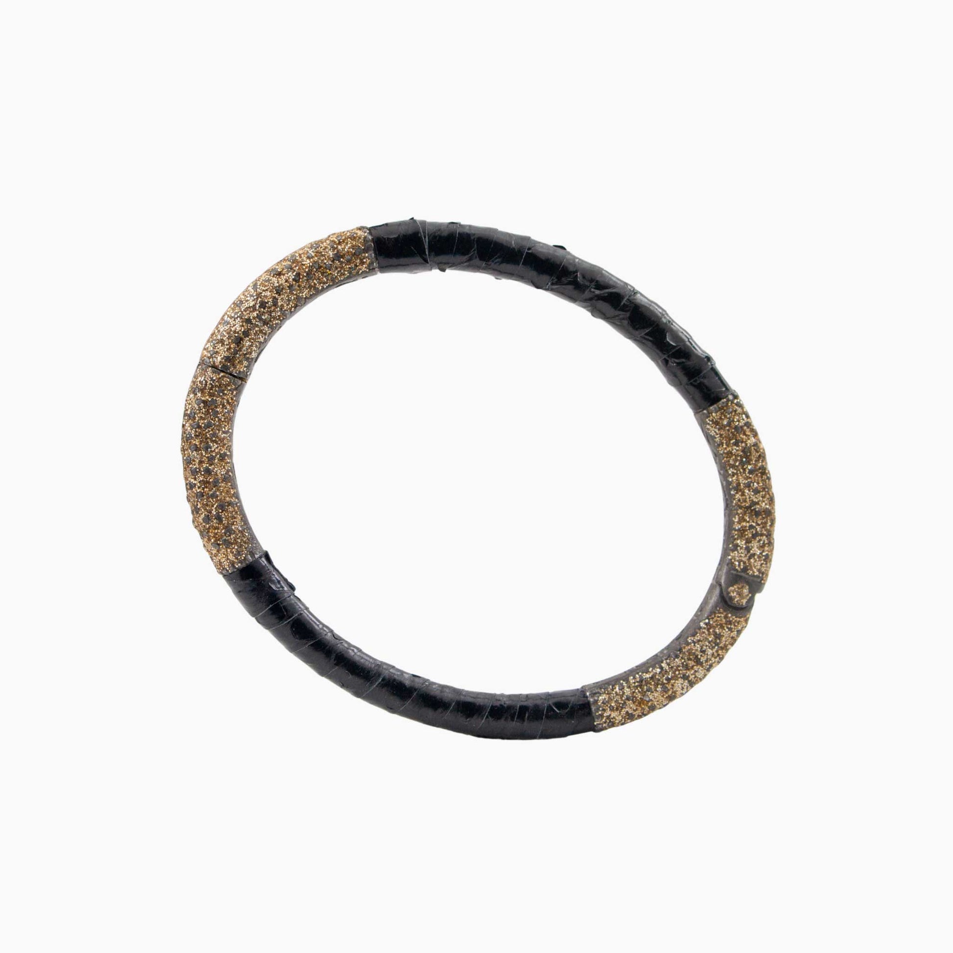 Black and gold bracelet on a white background
