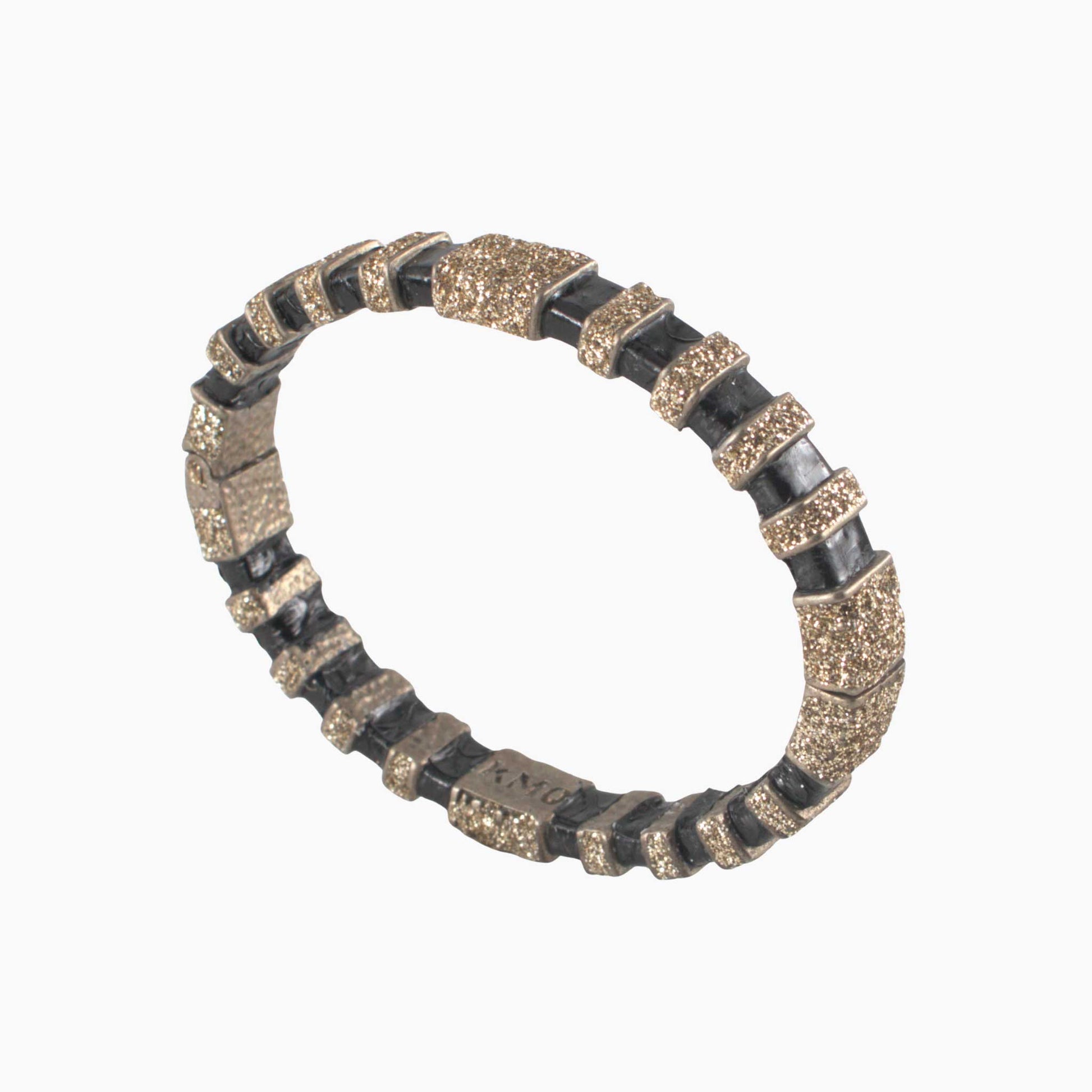 Bracelet with black and gold pattern on a white background