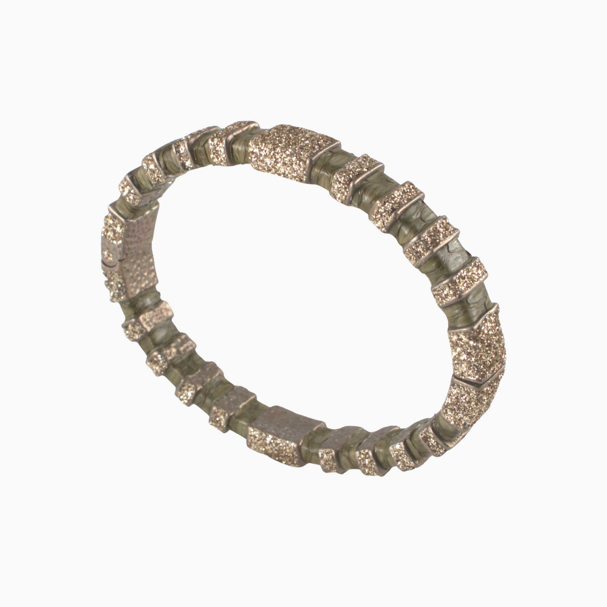 Decorative ring with textured design on a white background