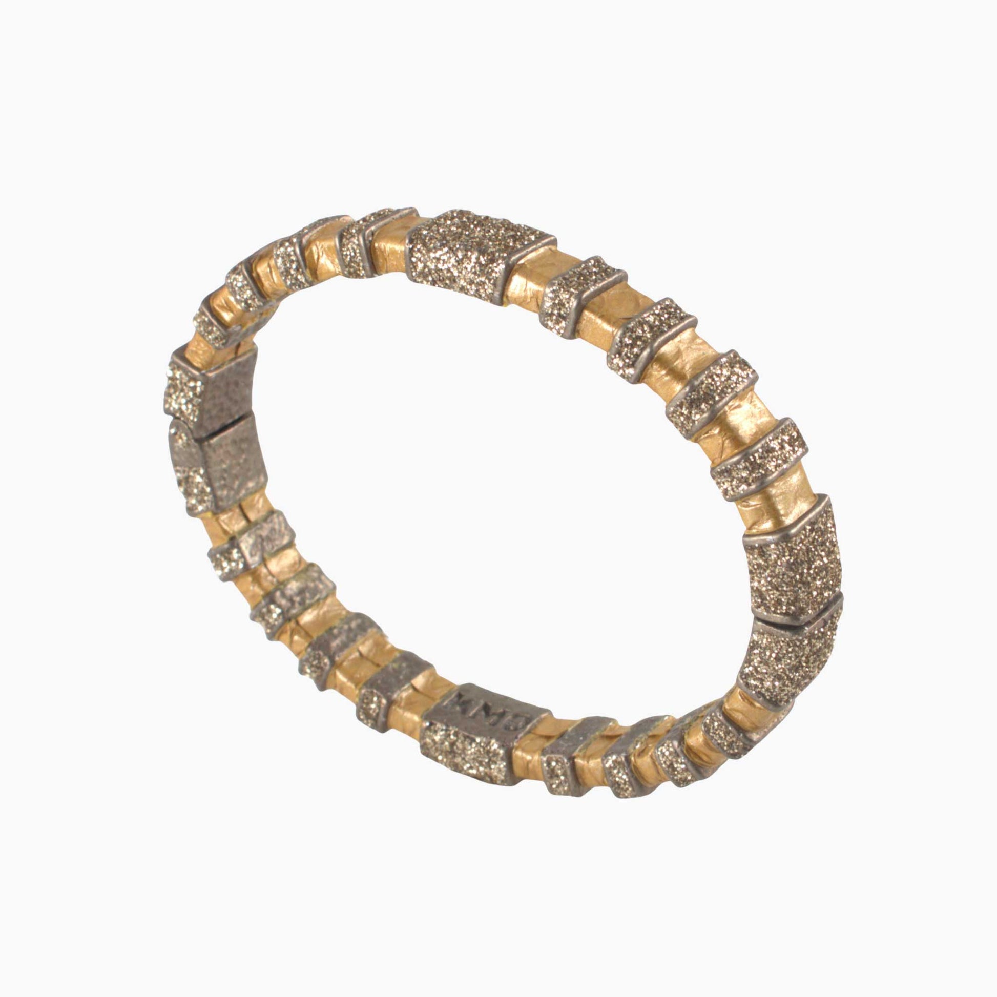 Bracelet with gold and silver beads on a white background