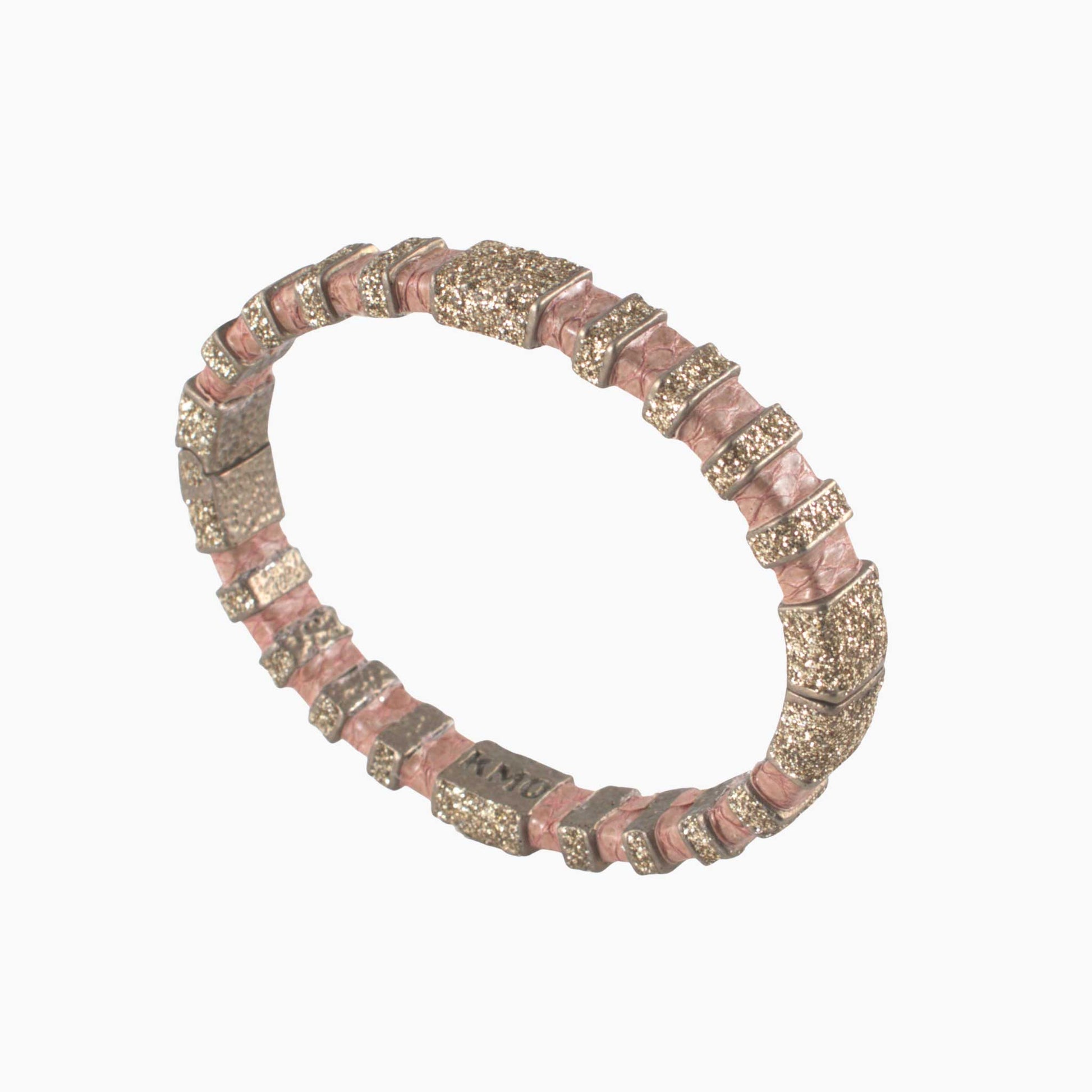 Bracelet with pink and gold beads on a white background