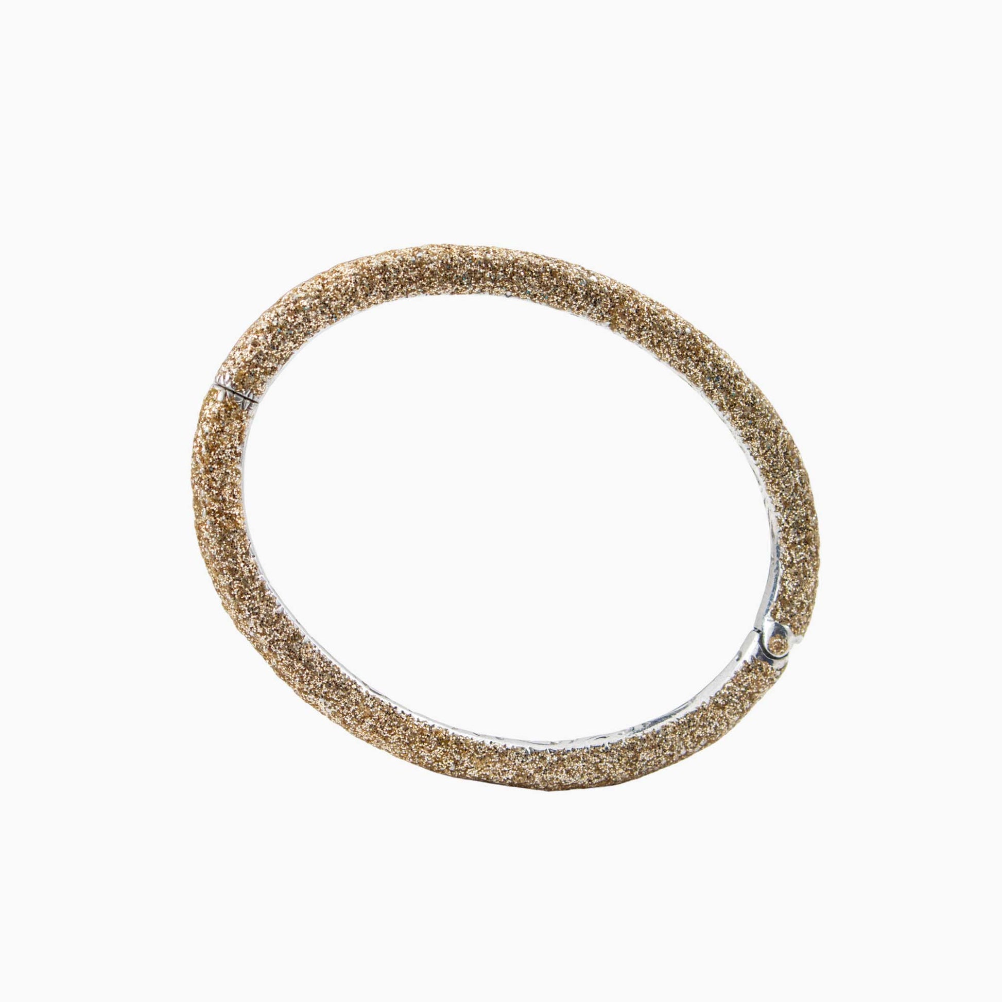 Gold glittery bracelet on a white background