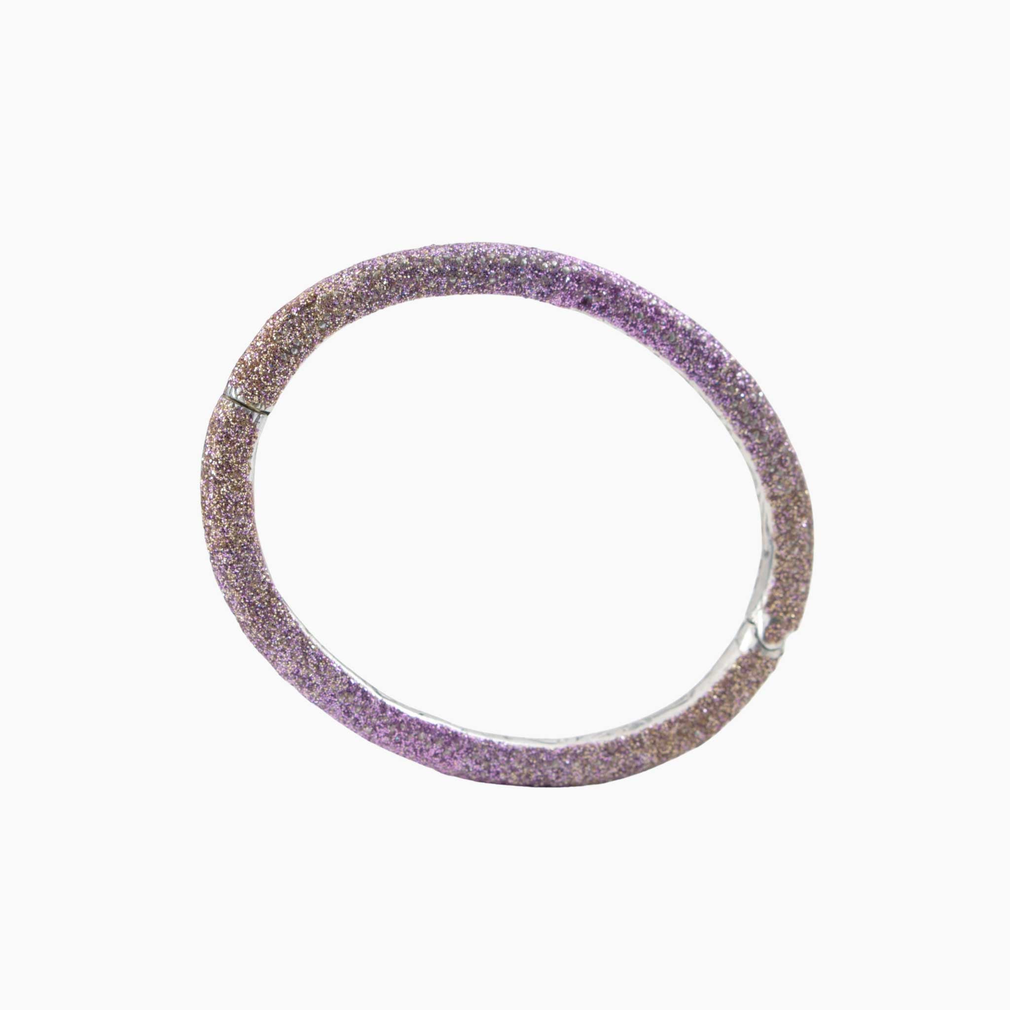 Purple glittery bangle on a white background