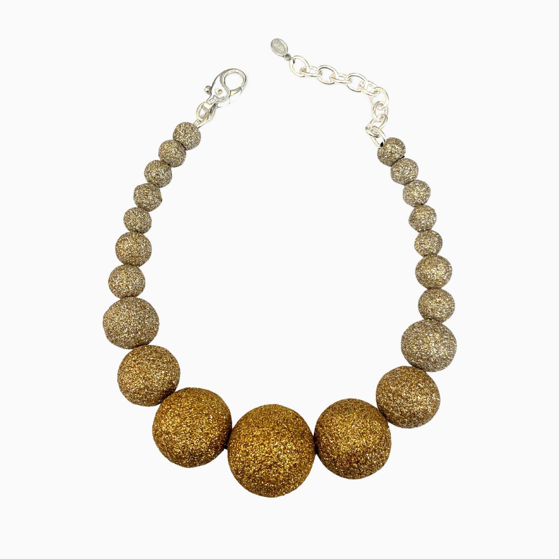 Gold beaded necklace on a white background