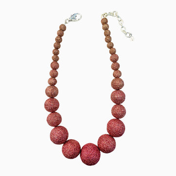 Necklace with red beaded design on a white background