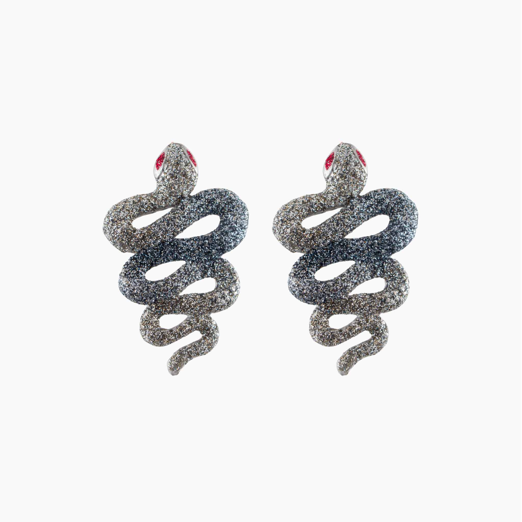 Snake-shaped earrings with glittery texture on a white background