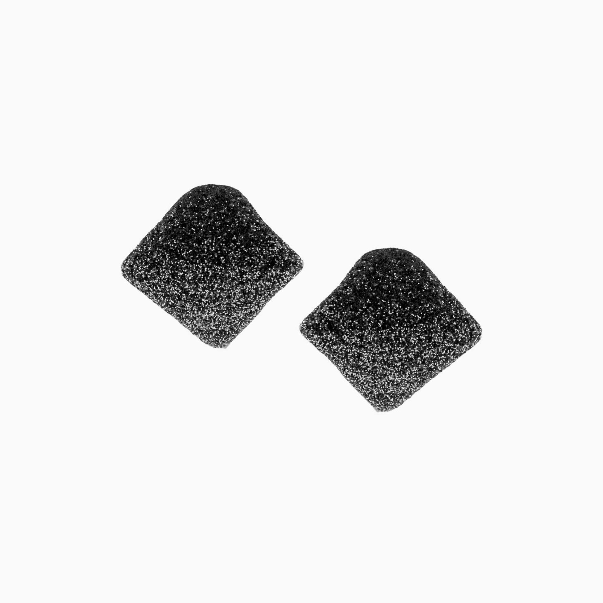 Two black earrings on a white background
