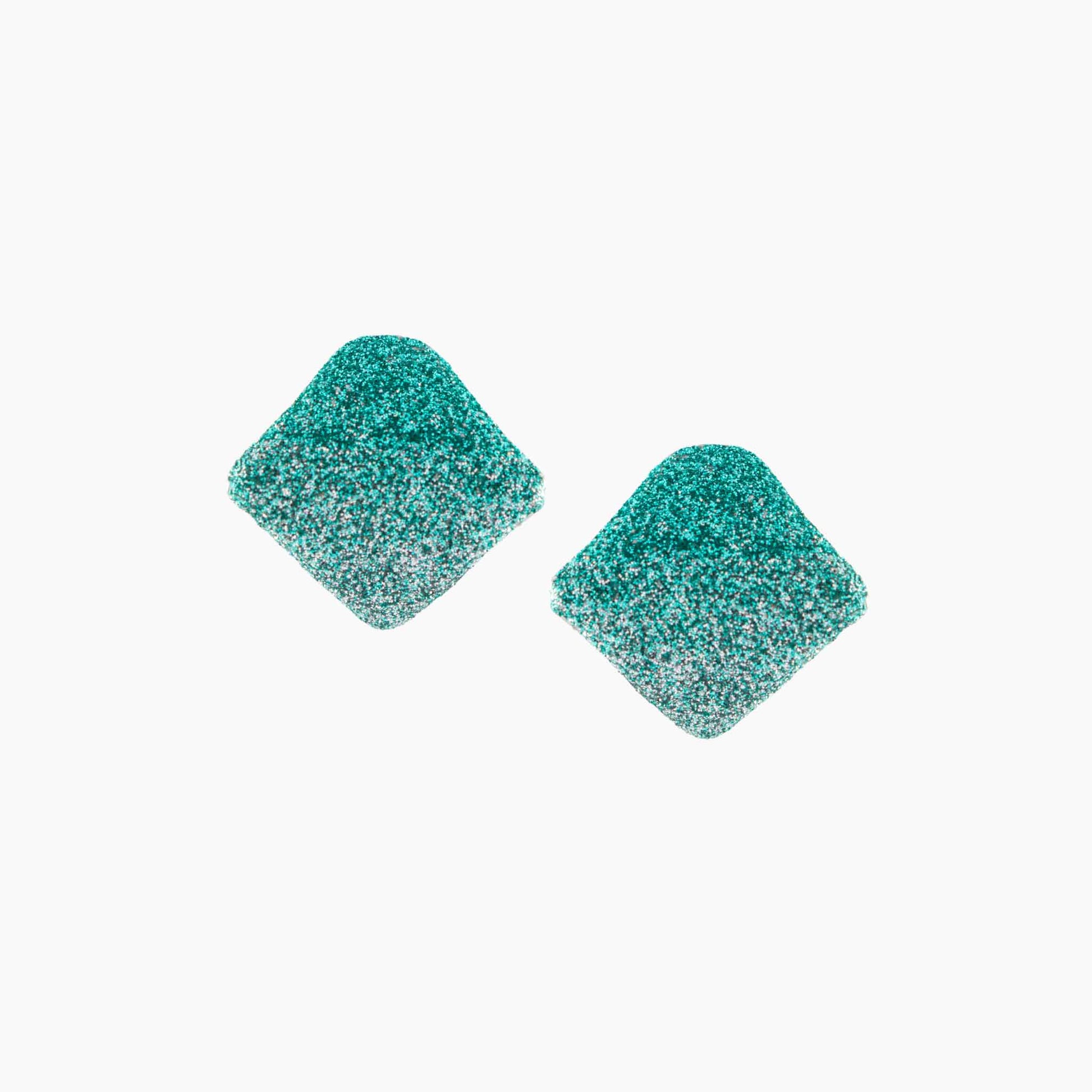Pair of teal glittery square earrings on a white background