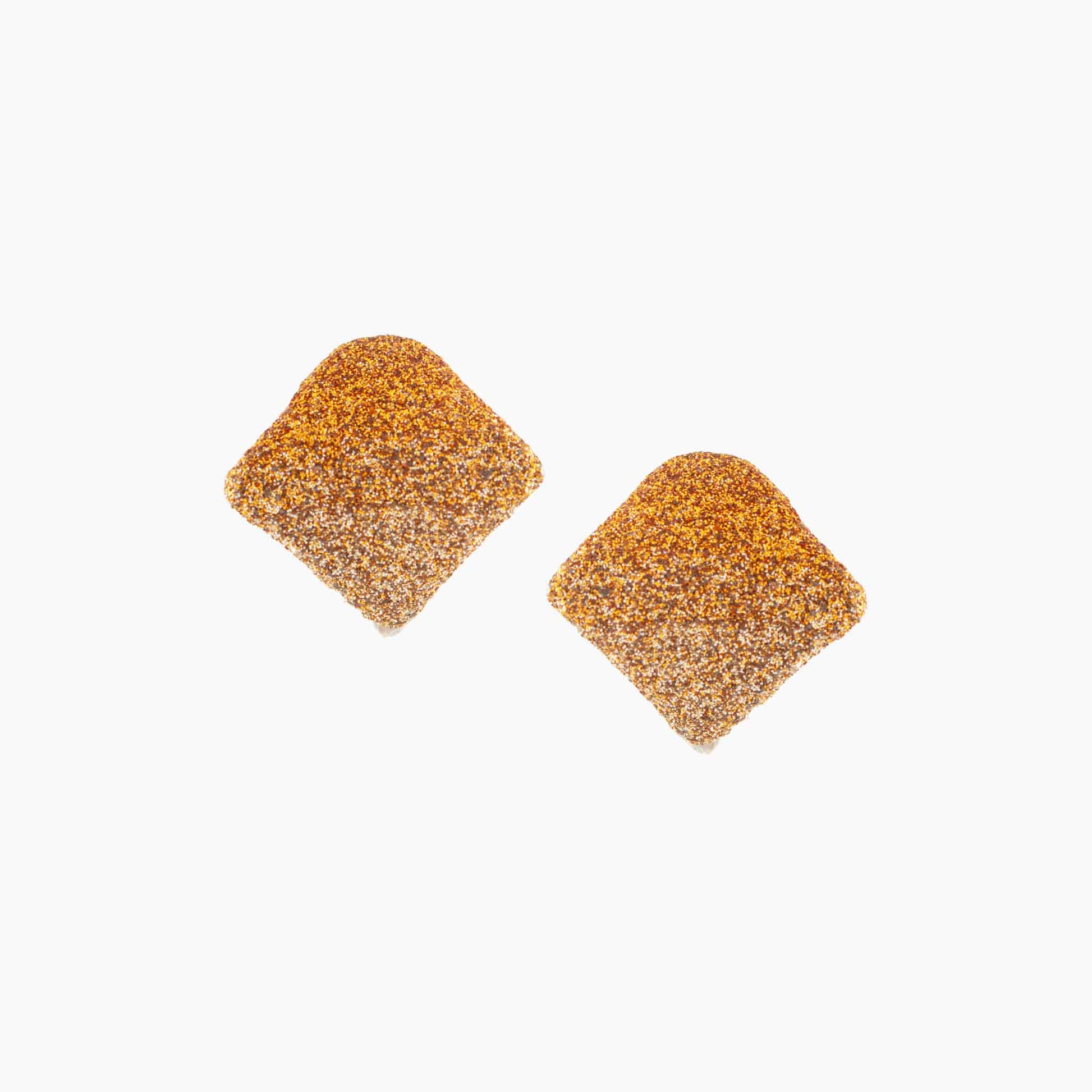 Pair of gold glittery earrings on a white background