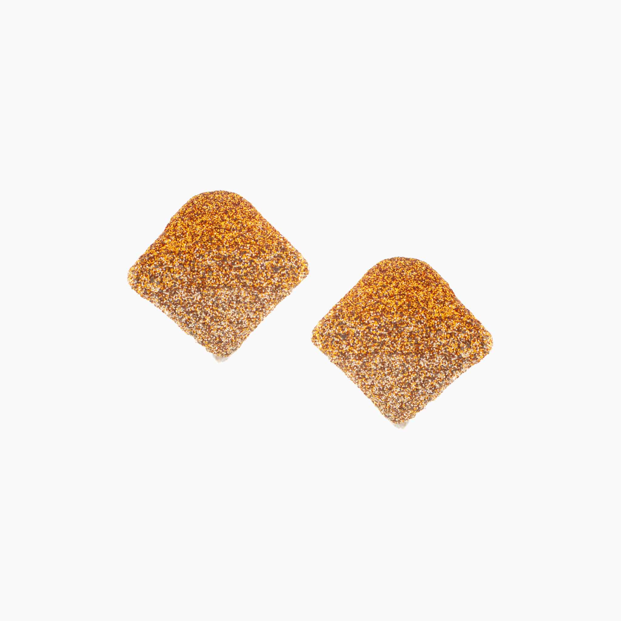 Pair of gold glittery earrings on a white background