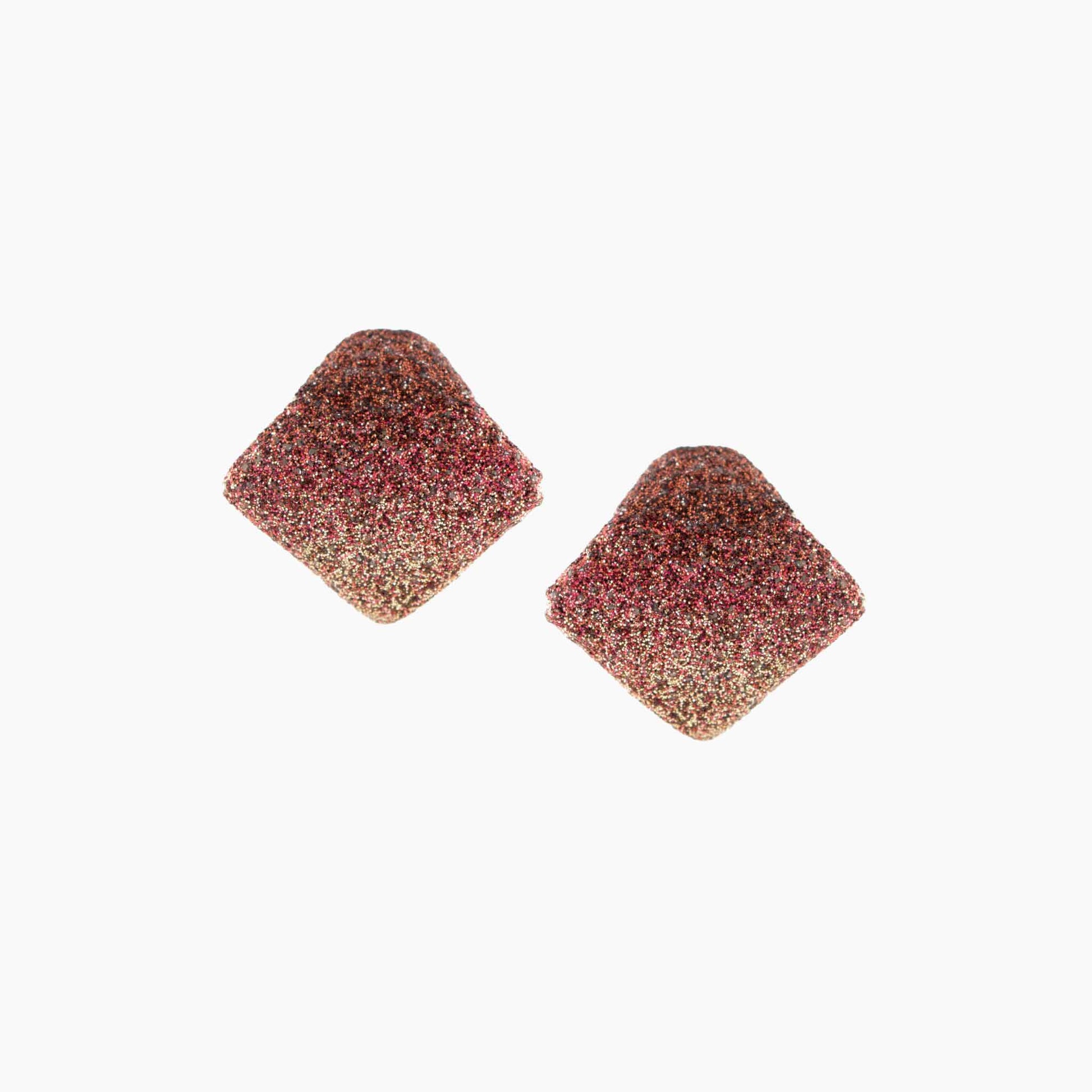 Pair of square-shaped earrings with a multicolored glittery finish on a white background