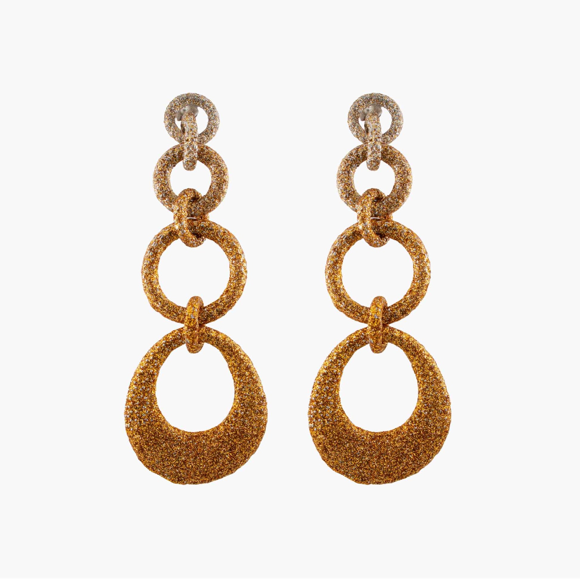 Pair of gold glittery hoop earrings on a white background