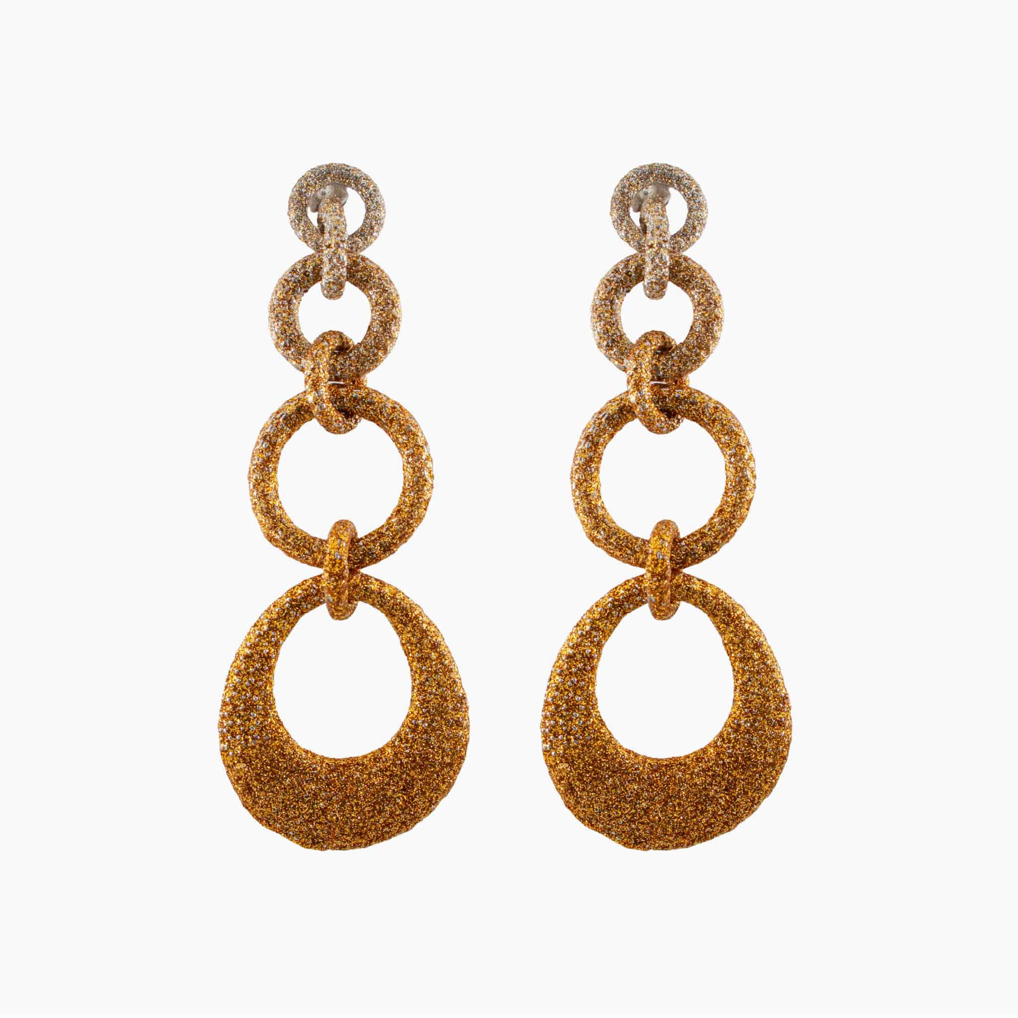 Pair of gold glittery hoop earrings on a white background