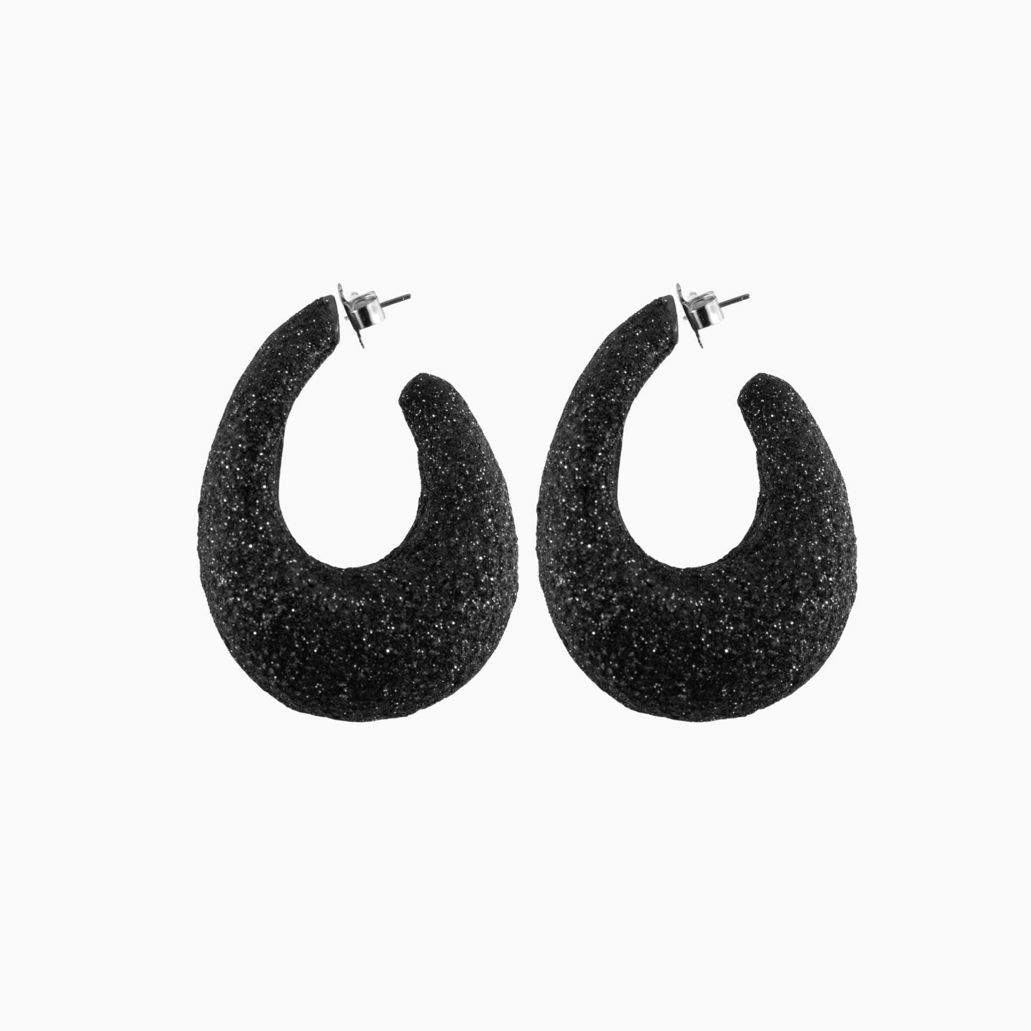 Black glittery hoop earrings on a white background