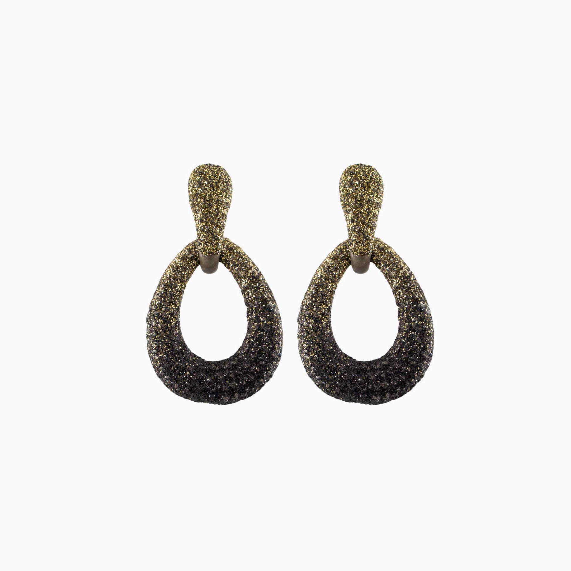 Pair of gold and black earrings on a white background