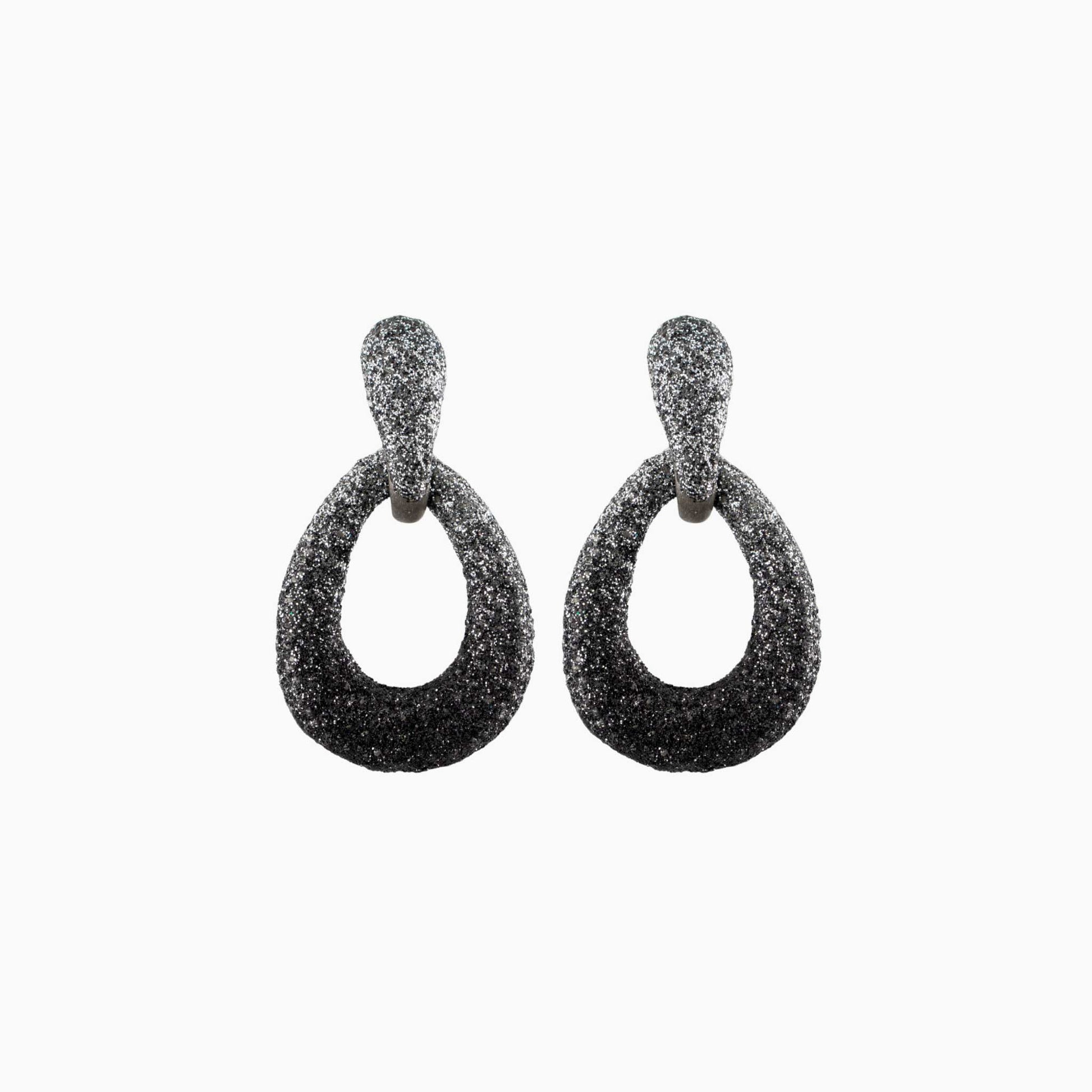 Pair of black glittery hoop earrings on a white background