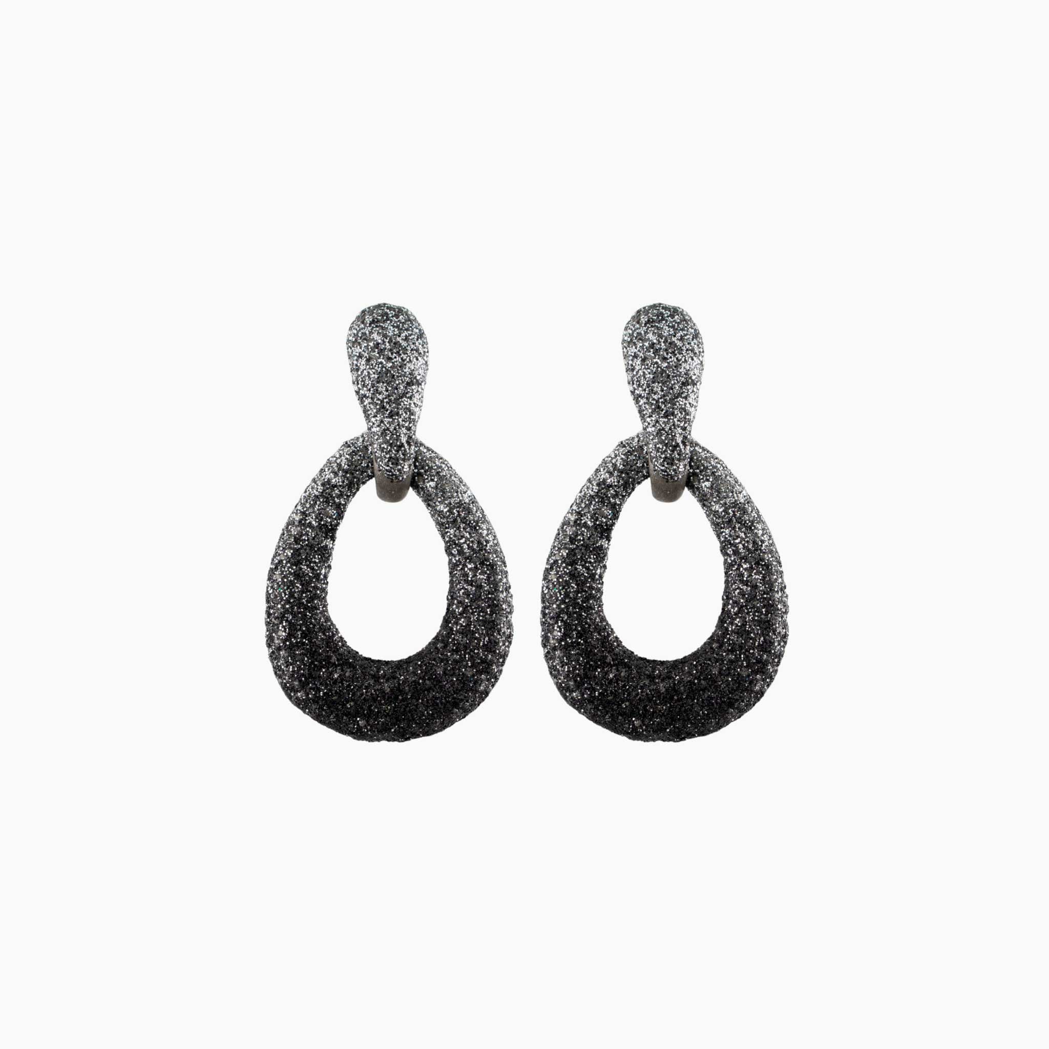 Pair of black glittery hoop earrings on a white background