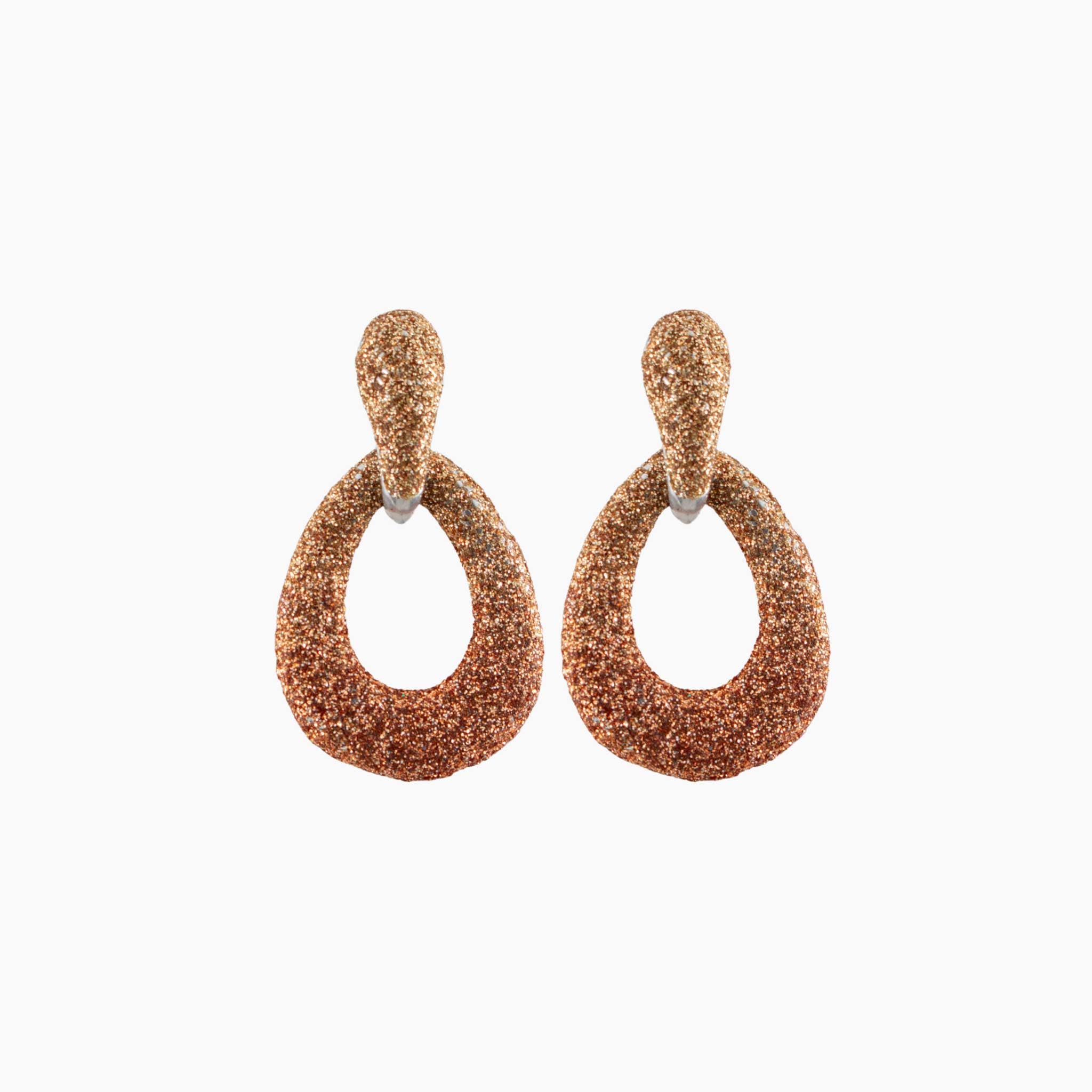 Pair of rose gold glittery hoop earrings on a white background