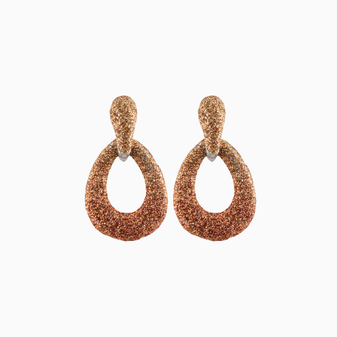 Pair of rose gold glittery hoop earrings on a white background