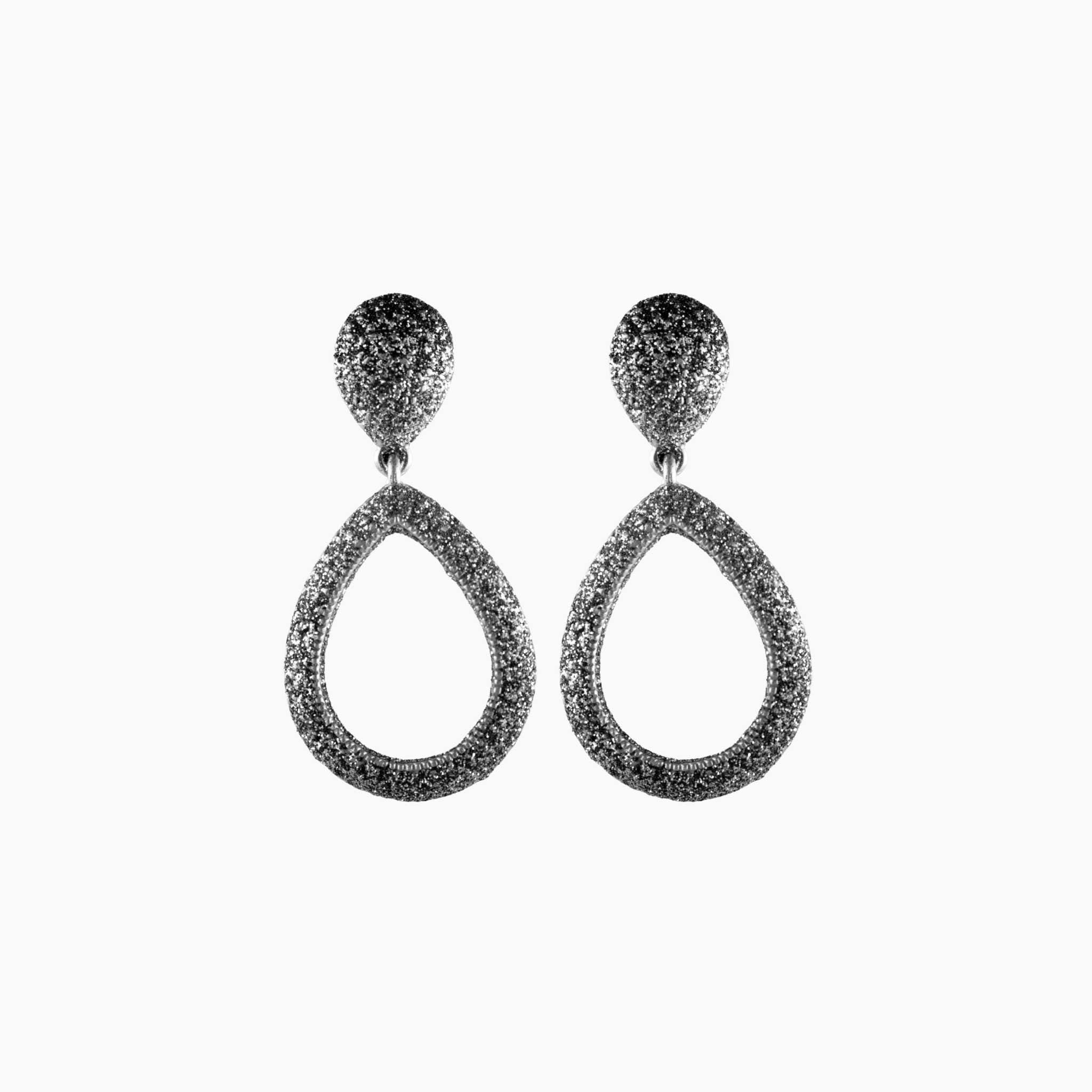 Pair of silver teardrop earrings on a white background