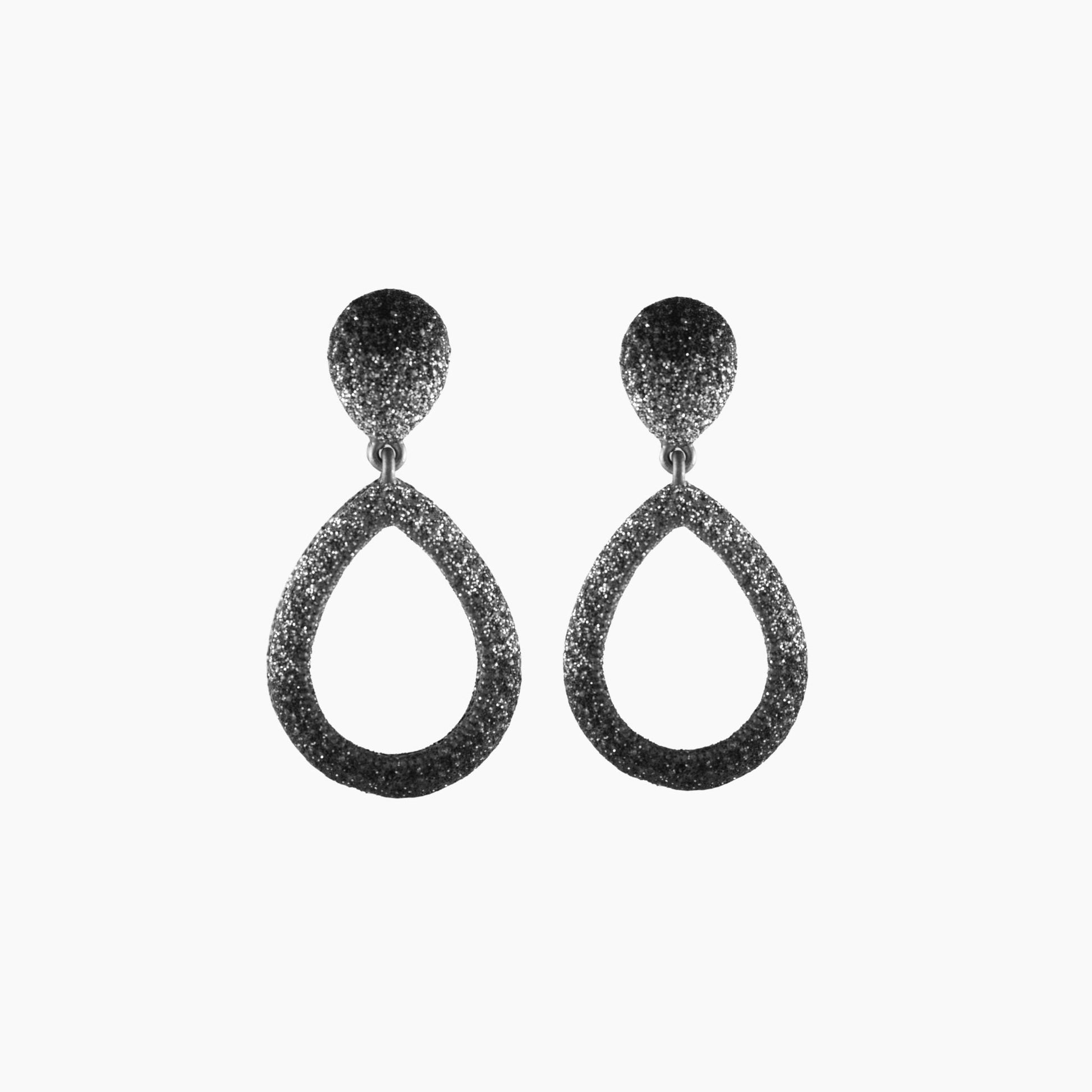Pair of black glittery teardrop earrings on a white background