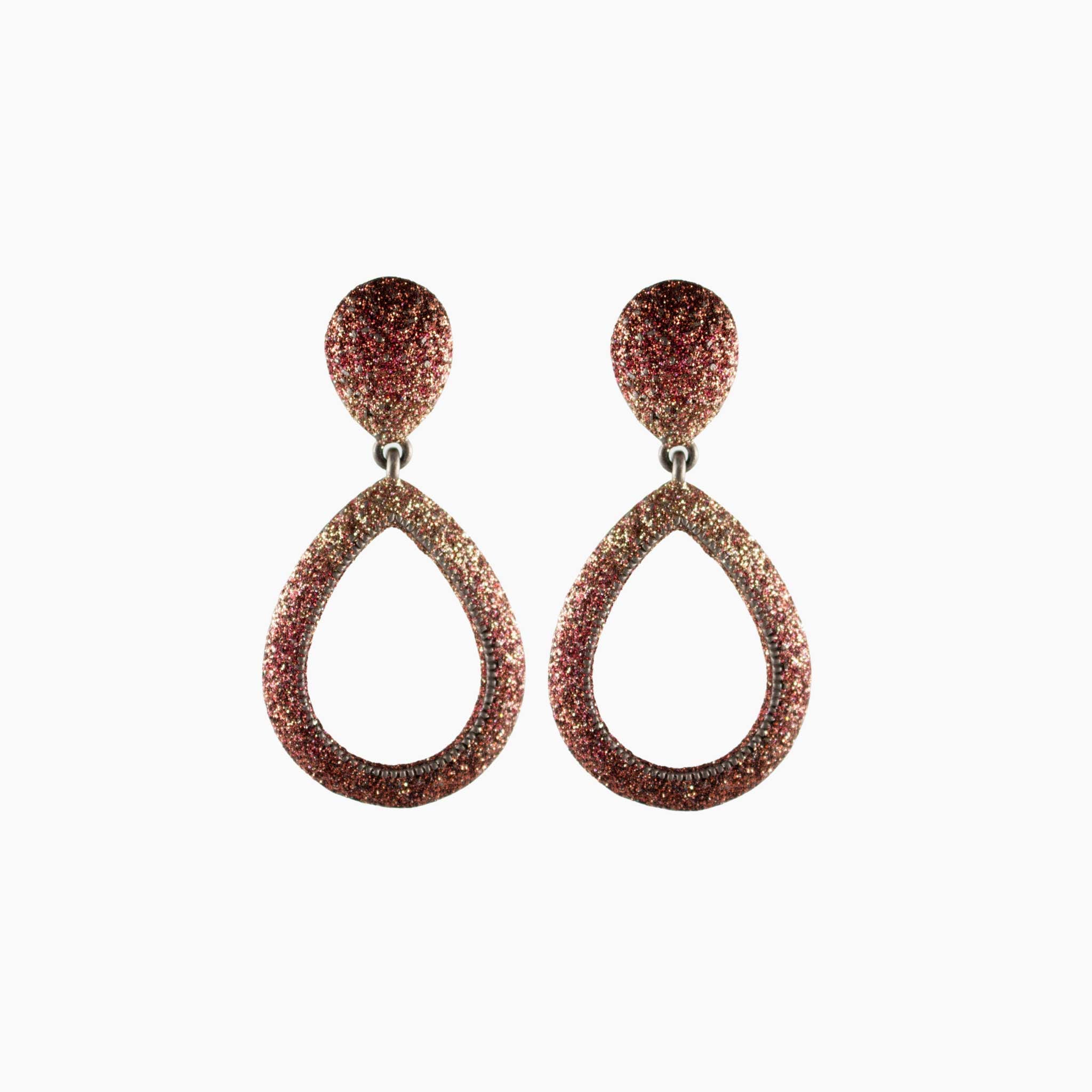 Pair of teardrop-shaped earrings with glittery finish on a white background