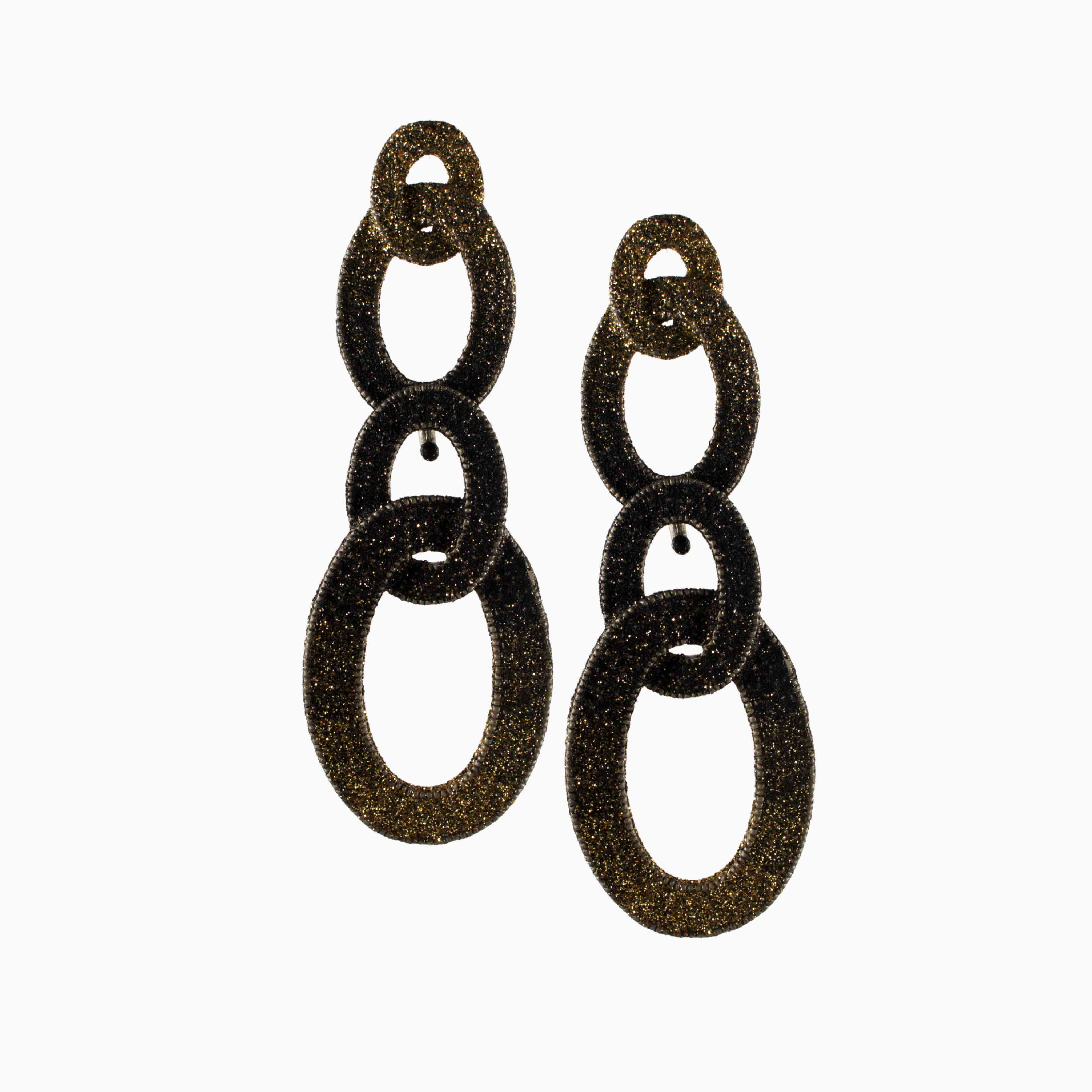 Pair of gold glittery drop earrings on a white background