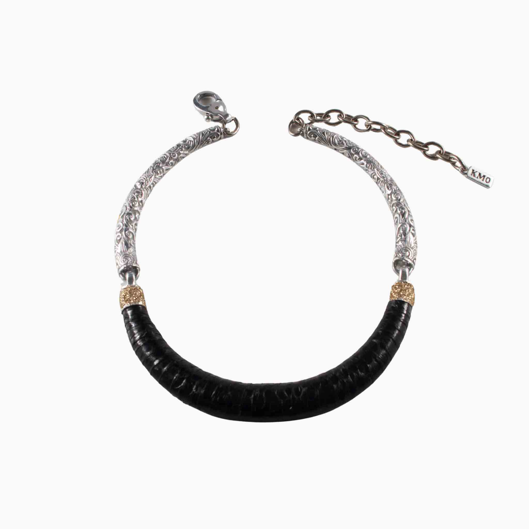 Necklace with black cylindrical pendant and silver chain on a white background