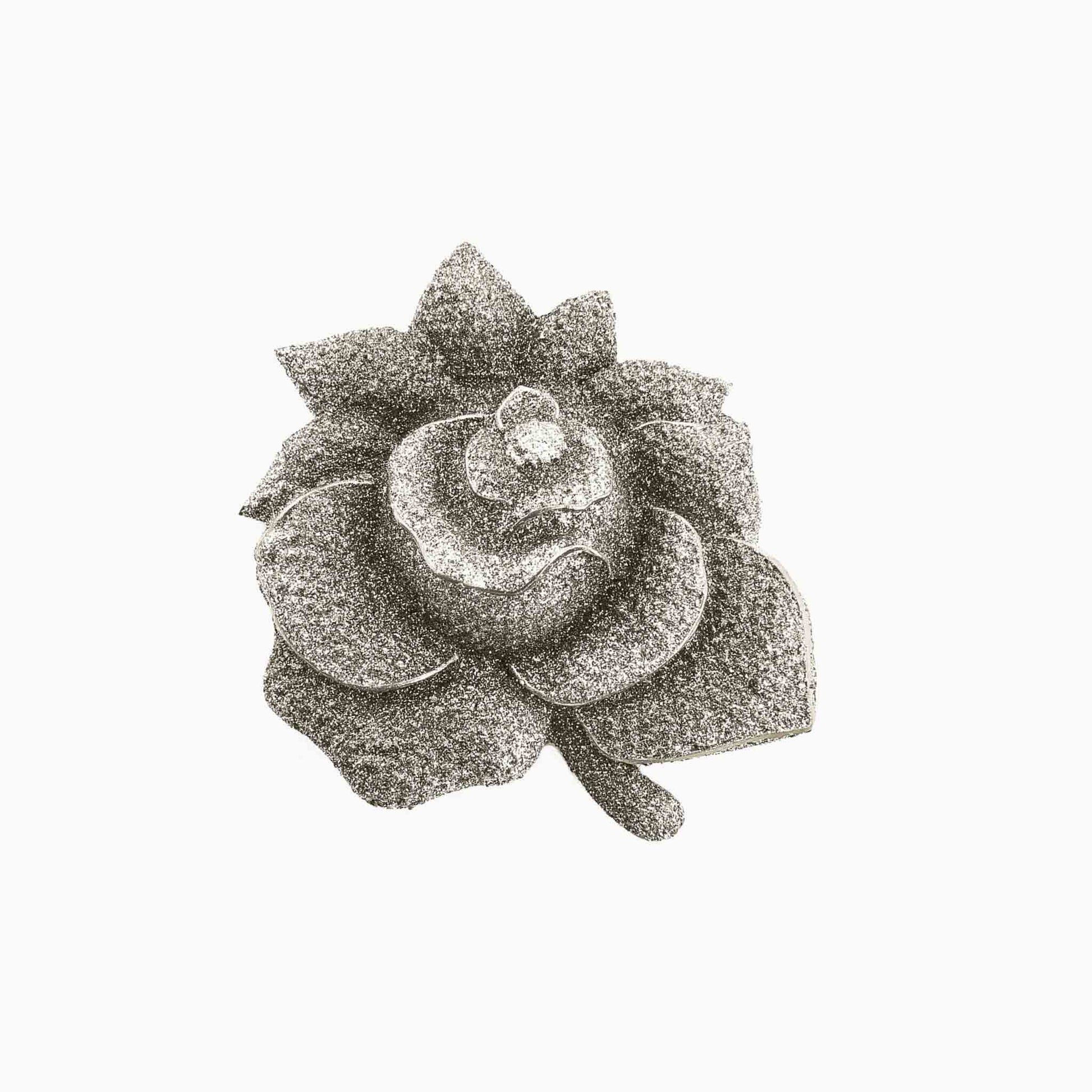 Decorative brooch with a floral design on a white background