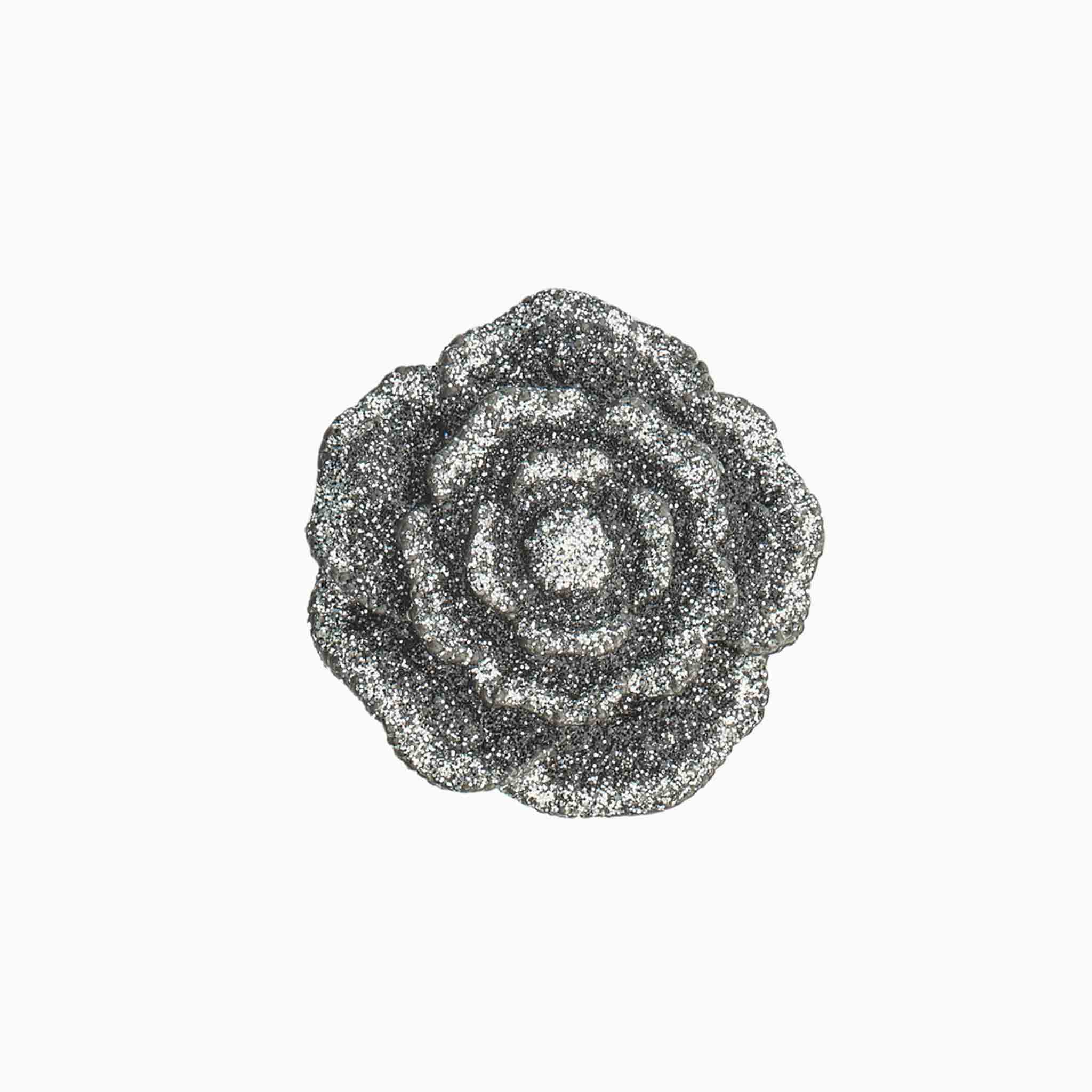 Decorative brooch with a floral design on a white background