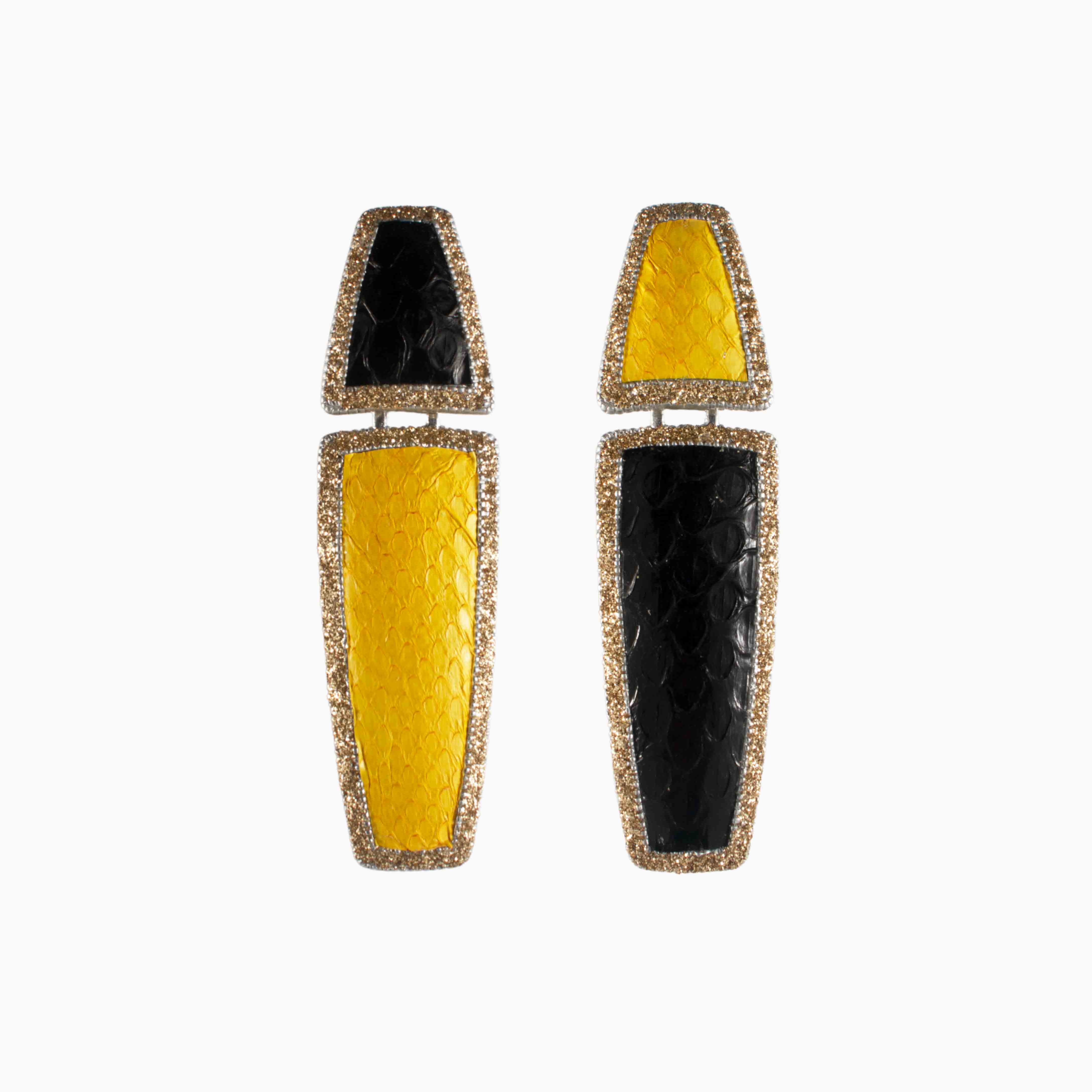 Pair of earrings with yellow and black design on a white background