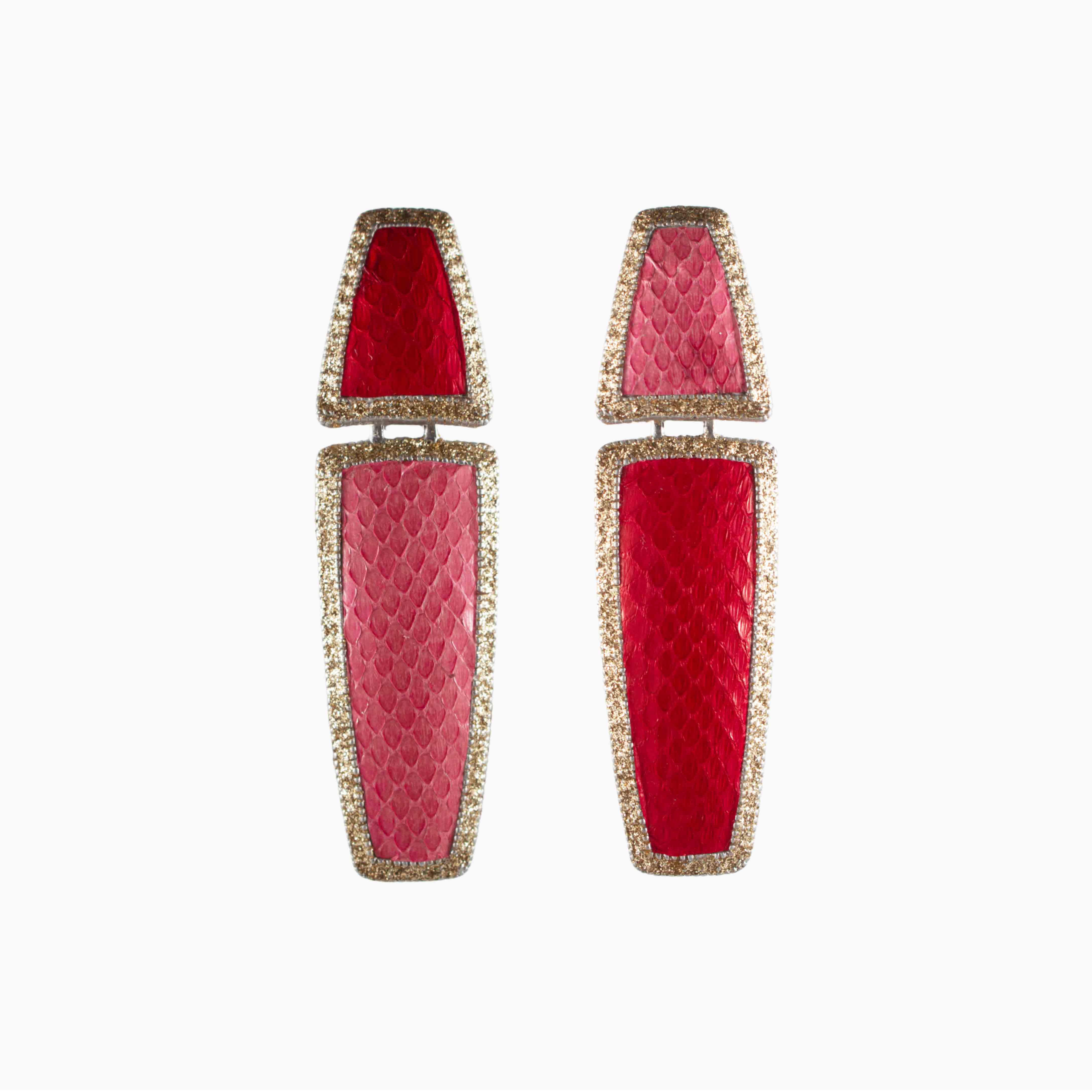 Pair of red earrings with gold accents on a white background