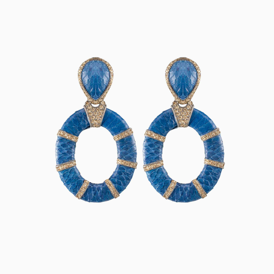 Pair of earrings with orange, black, and beige circular designs on a white background