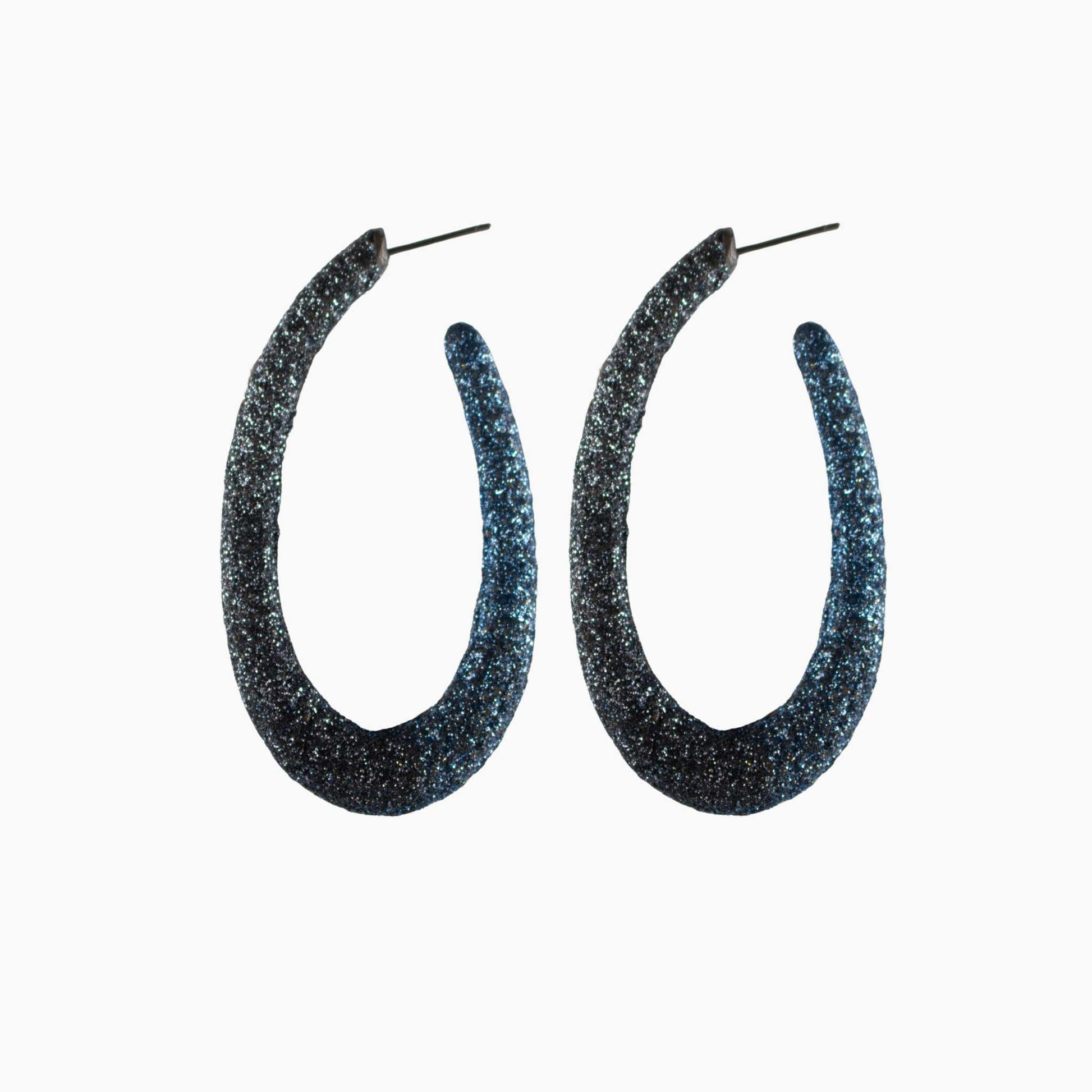 Pair of glittery hoop earrings on a white background