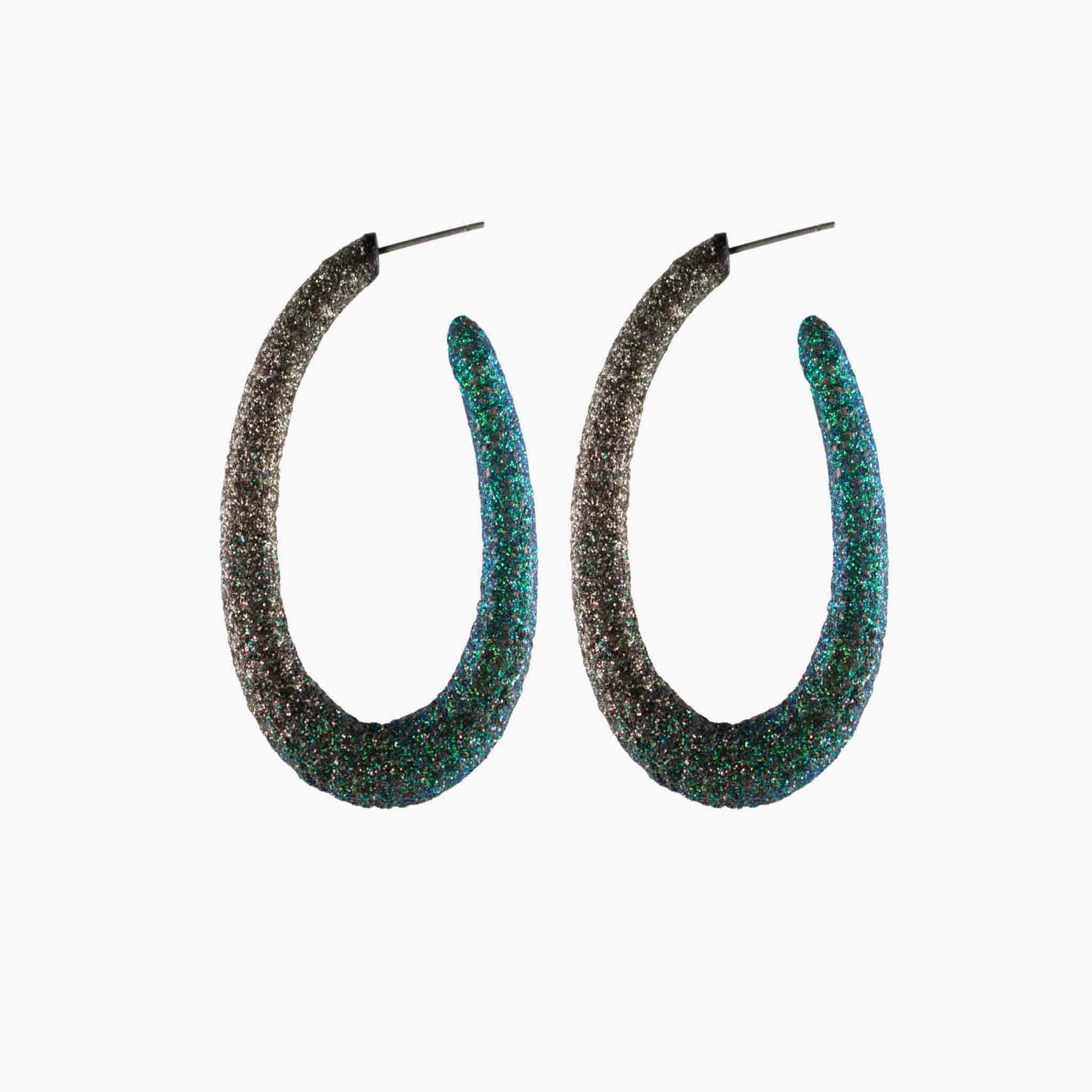Pair of glittery hoop earrings on a white background