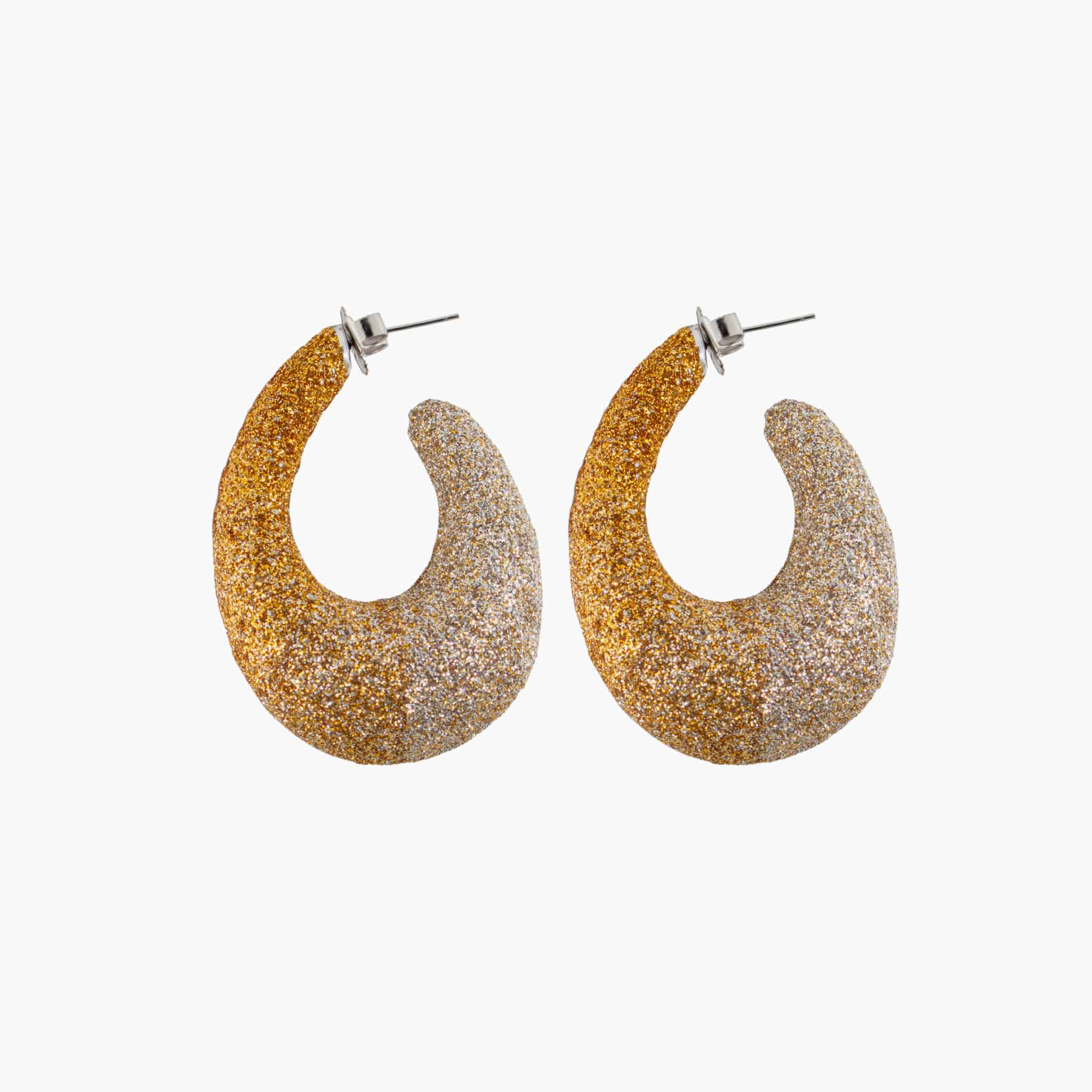 Gold and silver glittery hoop earrings on a white background