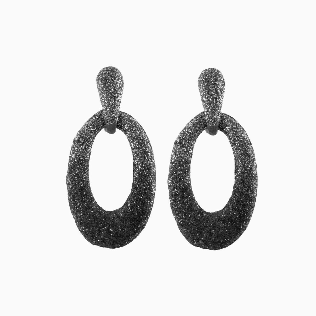 Pair of black glittery hoop earrings on a white background