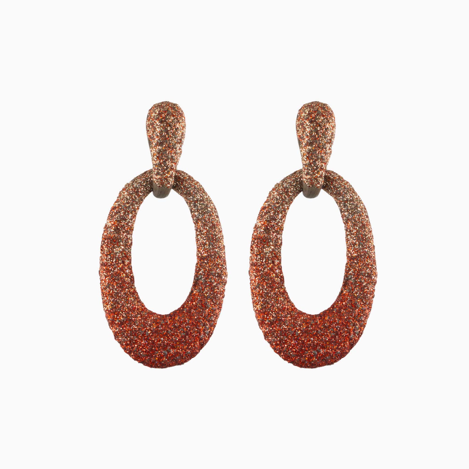 Pair of brown glittery hoop earrings on a white background