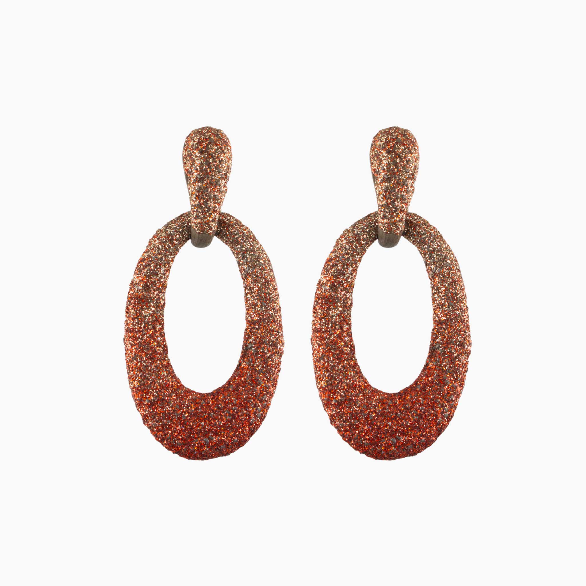 Pair of brown glittery hoop earrings on a white background