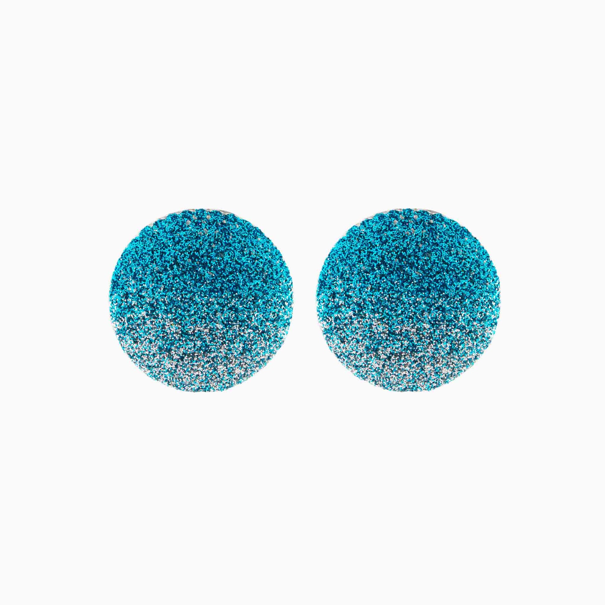 Pair of blue glittery round earrings on a white background