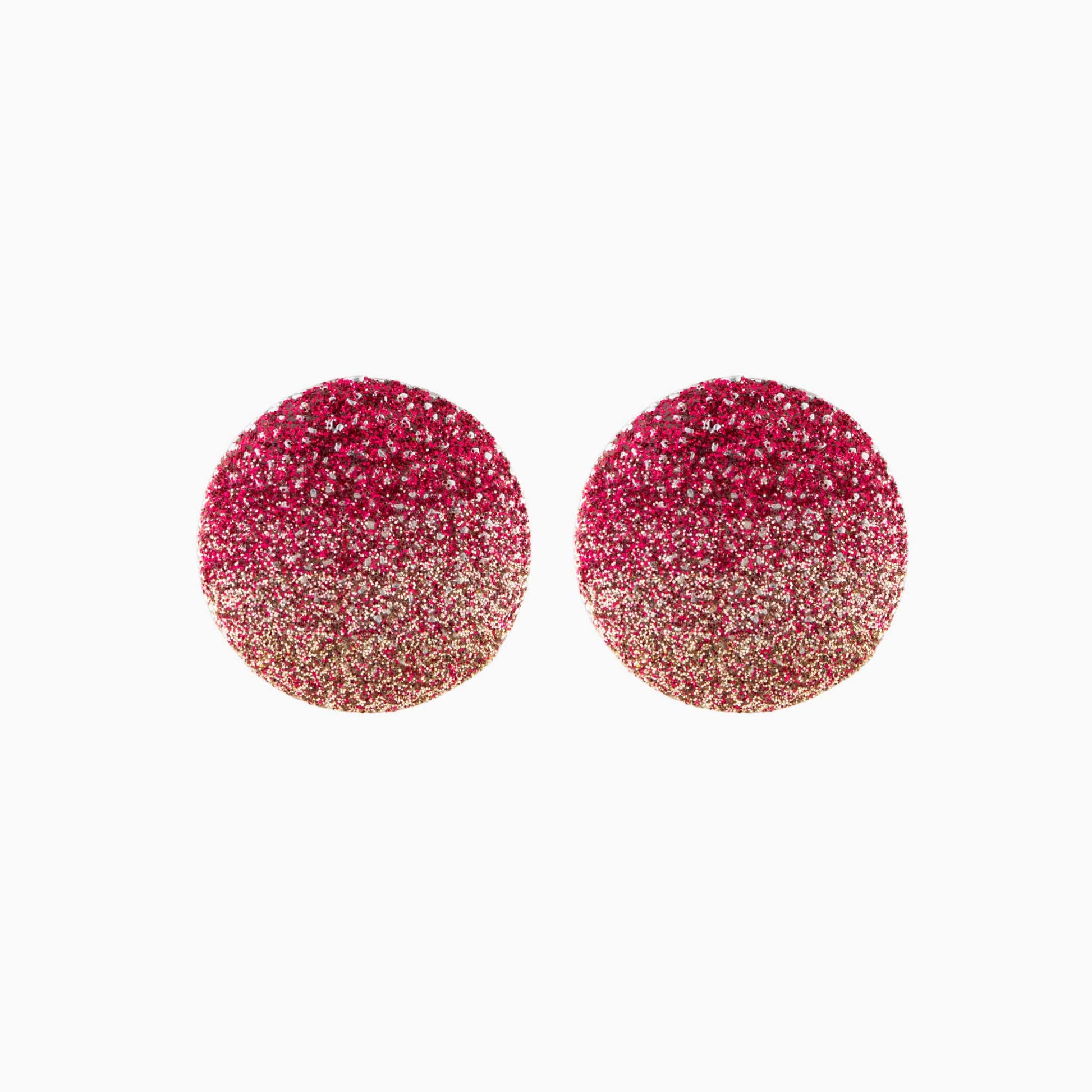Pair of red glittery round earrings on a white background