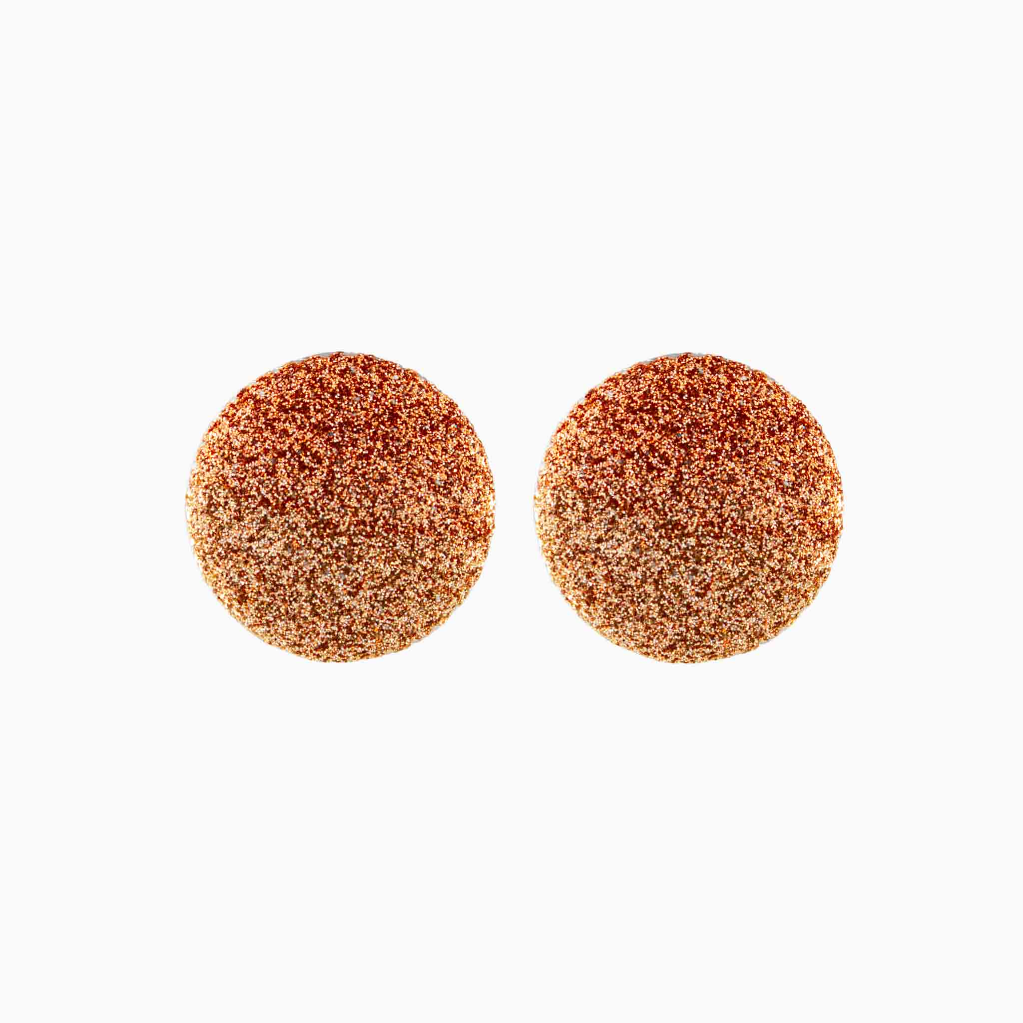 Pair of round, glittery earrings on a white background